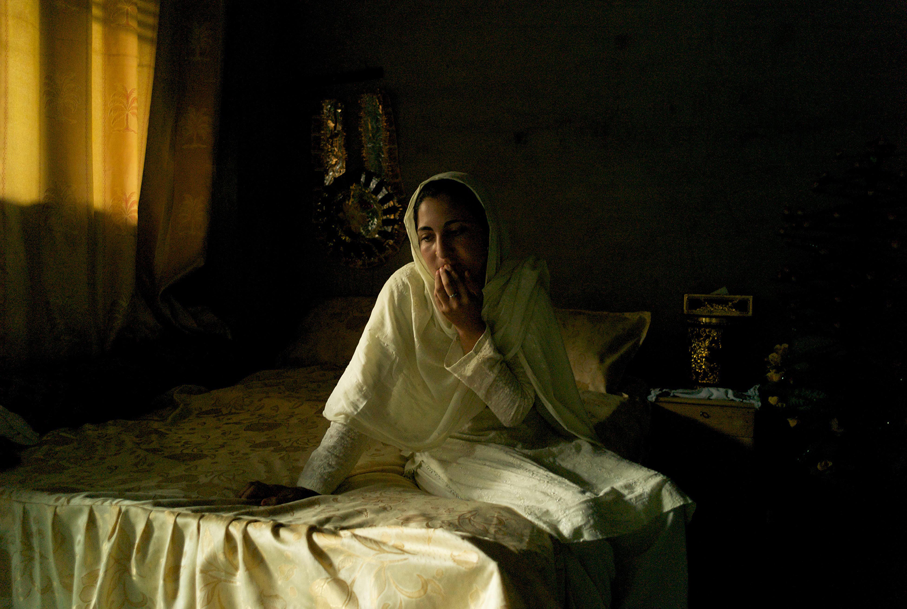  CHARBAGH, PAKISTAN- AUGUST 2009 
Twenty-eight year old mother of six Taslim sits in a state of depression on her marital bed following the beheading of her husband by the Taliban. Taslim's husband Sher Ahmed was returning home for the weekend after 