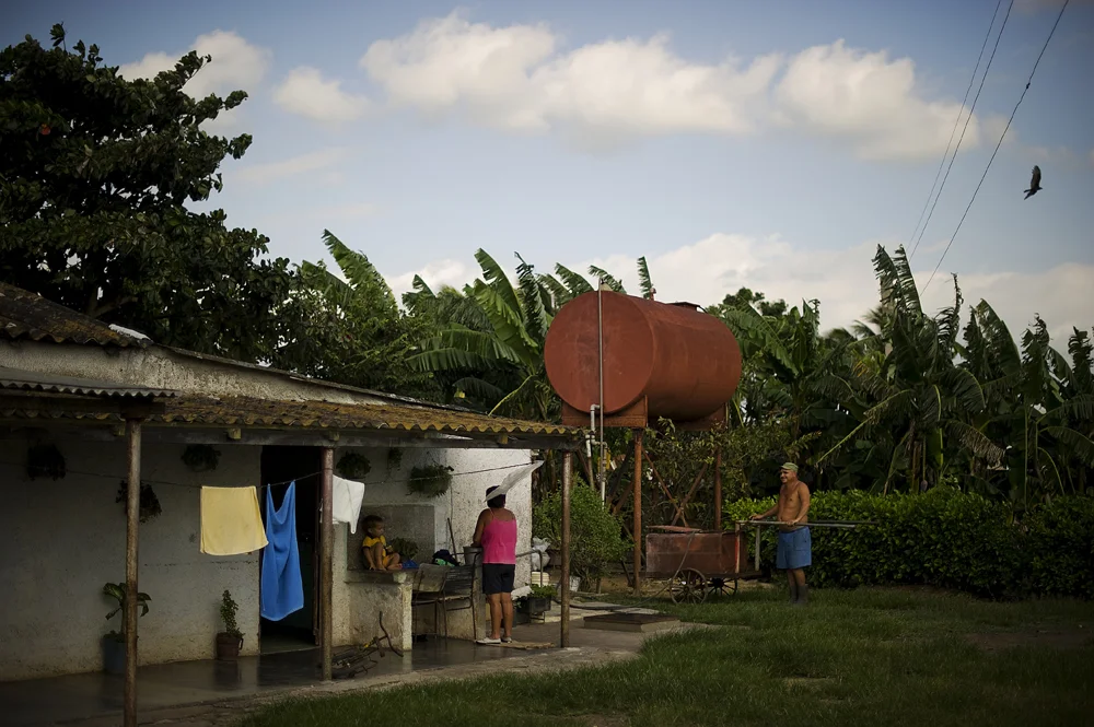 Carlos Lazos and Dagoberto Nunez together saved for two years and built a windmill for their two families in Altamisa, Cuba. The windmill powers the well where their water supply is powered. The mill cost the men and their familiies 2000 Cuban pesos which is a substantial sum of money in the small island country. The windmill was functioning, but they had two problems; the first was that the on/off handle was broken and they had to manually operate it by climbing the mill to turn it on or off and that some tubing had broken and it was unavailable at the local store. Therefore, the men had to fill up a large water bucket on wheels to carry the water to the other house. Resources and supplies are difficult to come by but it's far easier than pumping the water from the well by hand.
The Cuban Solution
�The amount and type of energy we consume is a result of two kinds of choices: those we make as a society and those we make as individuals and families.�
The World Watch Institute
In our over-developed, hyper-consumer-centric world we tend to think of climate change solutions in terms of technology. What new whizz-bang gadget can be invented for a seemingly easy fix that we can all benefit from? And these developments such as windmills, electric cars and solar energy are important, yet also significant and perhaps equally vital are the seemingly meaningless decisions that individuals make that significantly lower our carbon imprint.
Much can be learned from places where resources are scant and people must conserve. Examples of this are as simple as growing food locally in community gardens, using public transportation, riding a bicycle when where we would take our car and recycling. Although, in developed countries such as the United States, these �innovations� are not yet common, Cuba is one country that has been forced into these �solutions� by necessity.
In 1991 the Soviet Union pulled out of country and Cuba was left to fend for itself.
The ample and contin