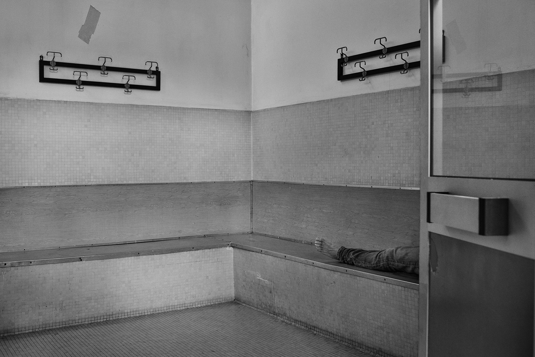  A public showers’ user rest at the entrance of the Public Baths of Via Bianzé in Turin, Italy; December 2018.
The city of Turin still runs 4 communal baths - part of a much bigger series of 15 buildings erected between 1900 and 1960 - offering a bas