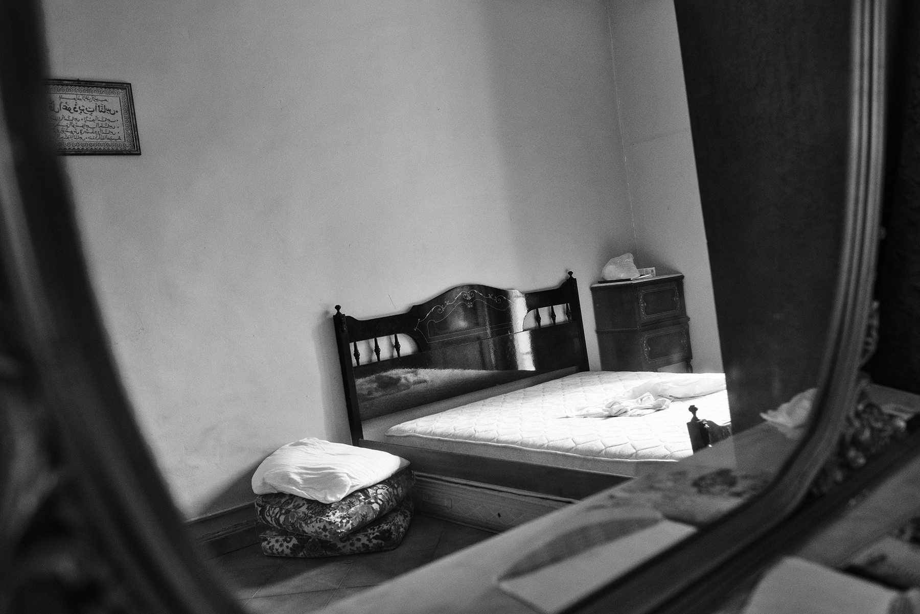  The sleeping room of an apartment inhabited by a family of four, with a shared toilet on the balcony, in the working class district of Barriera di Milano in Turin; July 2017. 