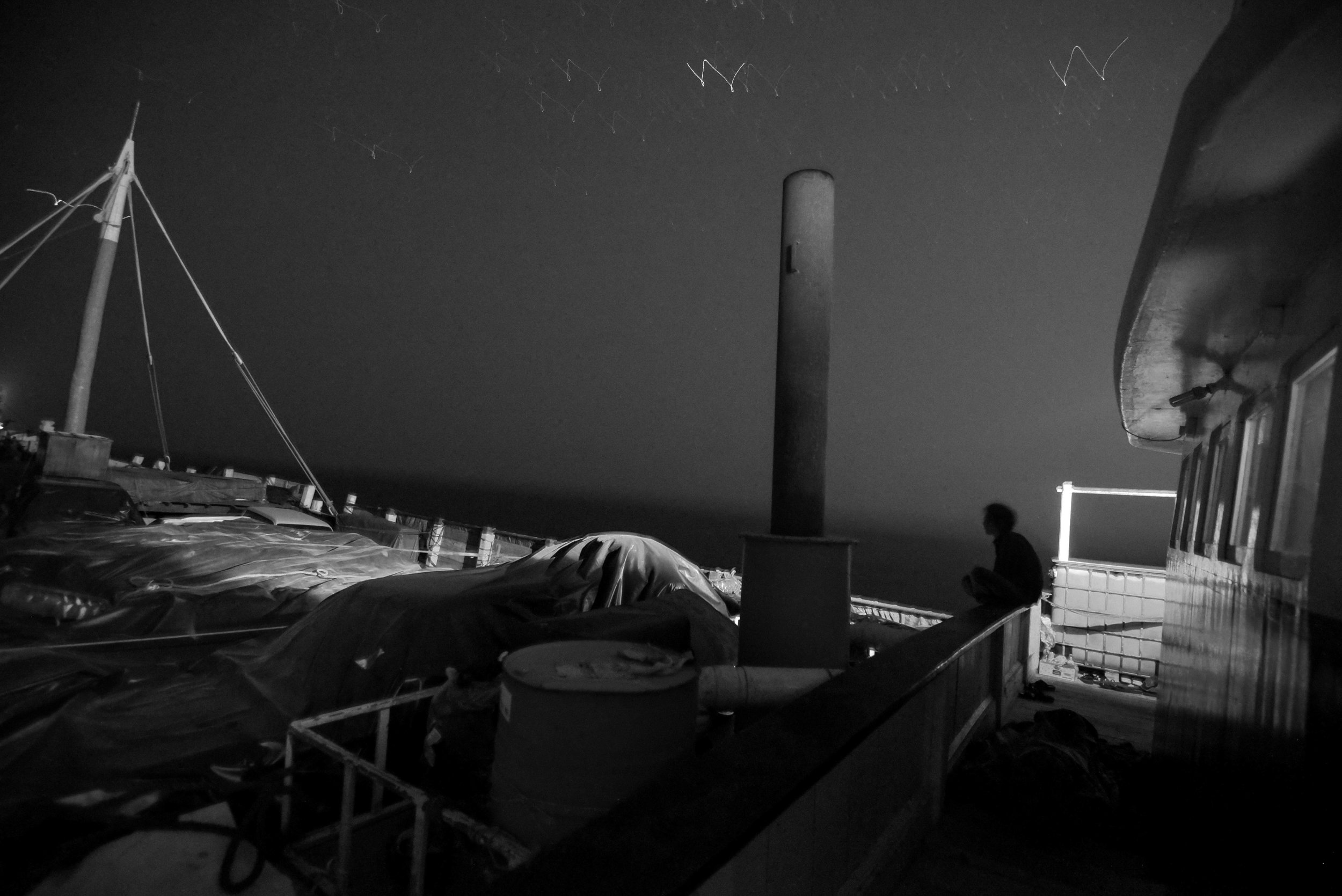  Project Socotra: The invisible Island February 2019
Cargo Ship from Oman to Socotra Island. Indian sailor on a night watch. Twelve Indians work on the small wooden ship, caring cement. They work for around 150$ a month. They don't have cabins, but 