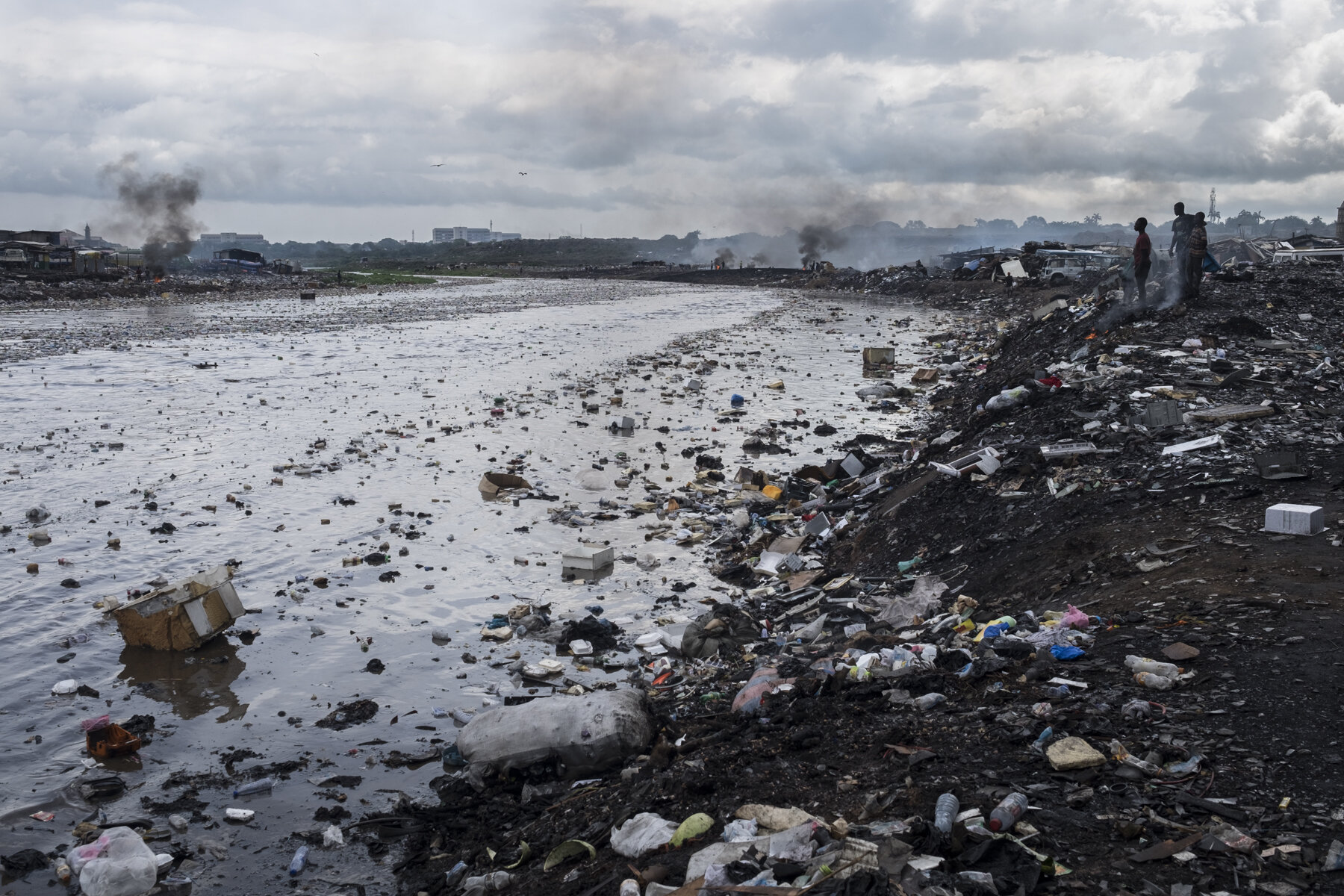  Ghana, Accra, October 2018.  The Odaw river divides the Sodom and Gomorrah slum from the Agbogbloshie scrap yard, known also for being one of the biggest electronic waste dumps in the world. Despite the initiatives of ecological restoration, the riv