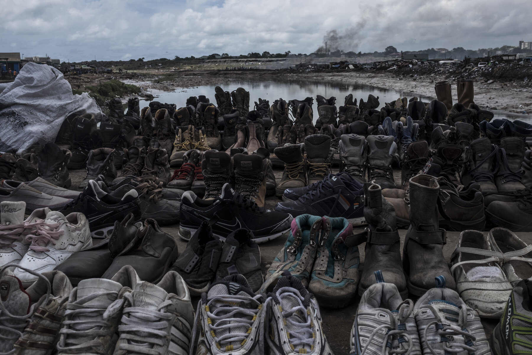  Ghana, Accra, October 2018. Shoes on sale on the bridge linking the Agbogbloshie scrap yard to the Sodom and Gomorrah slum. 