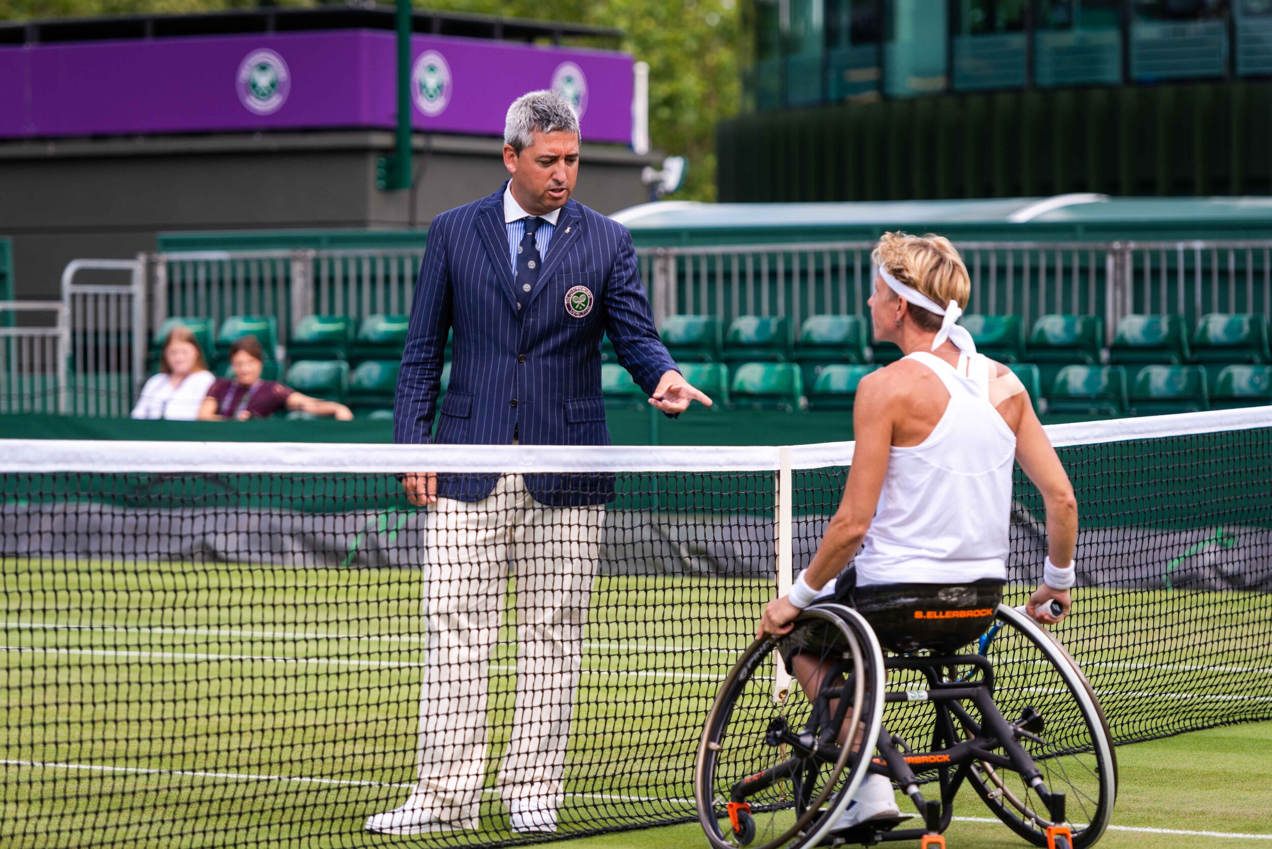  The referee urges Sabine to change her shirt. One of the sponsors exceeds the approved size. 