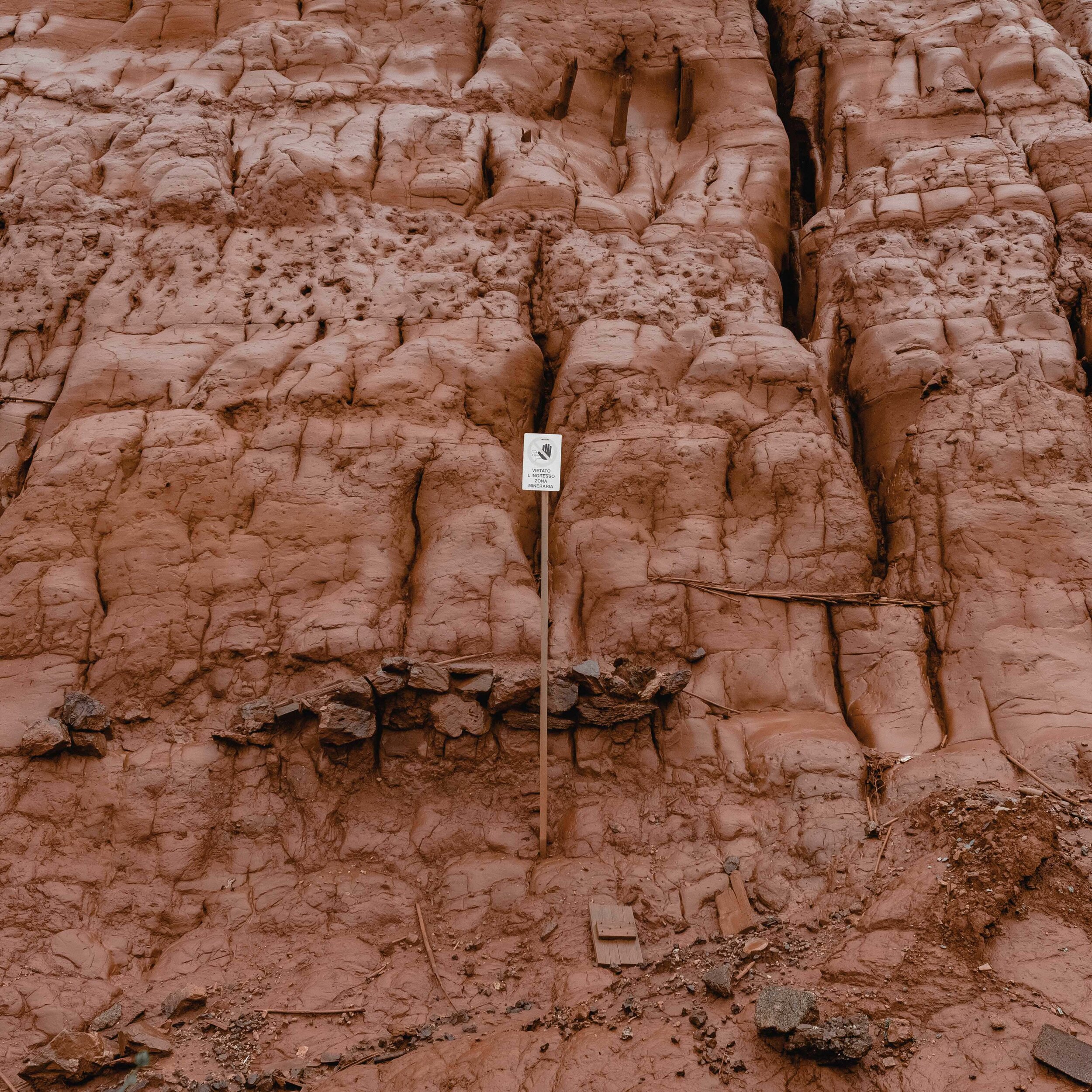  a dump of red mud is a testimony of the metallurgical activities of the Monteponi mine plants. The mud is red due to its high iron content. When it rains, spills contaminate adjacent waterways 