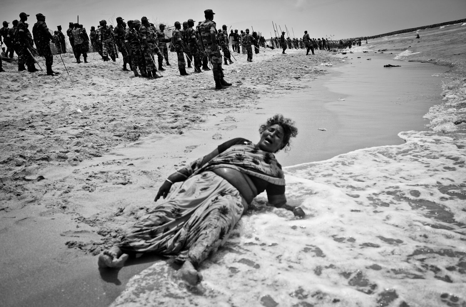  Xavieramma, a resident of Idinthakarai, cries out for help after being chased into the sea with no place to run. She was later helped out and arrested by the security forces. She has been charged with 16 cases including serious charges like sedition