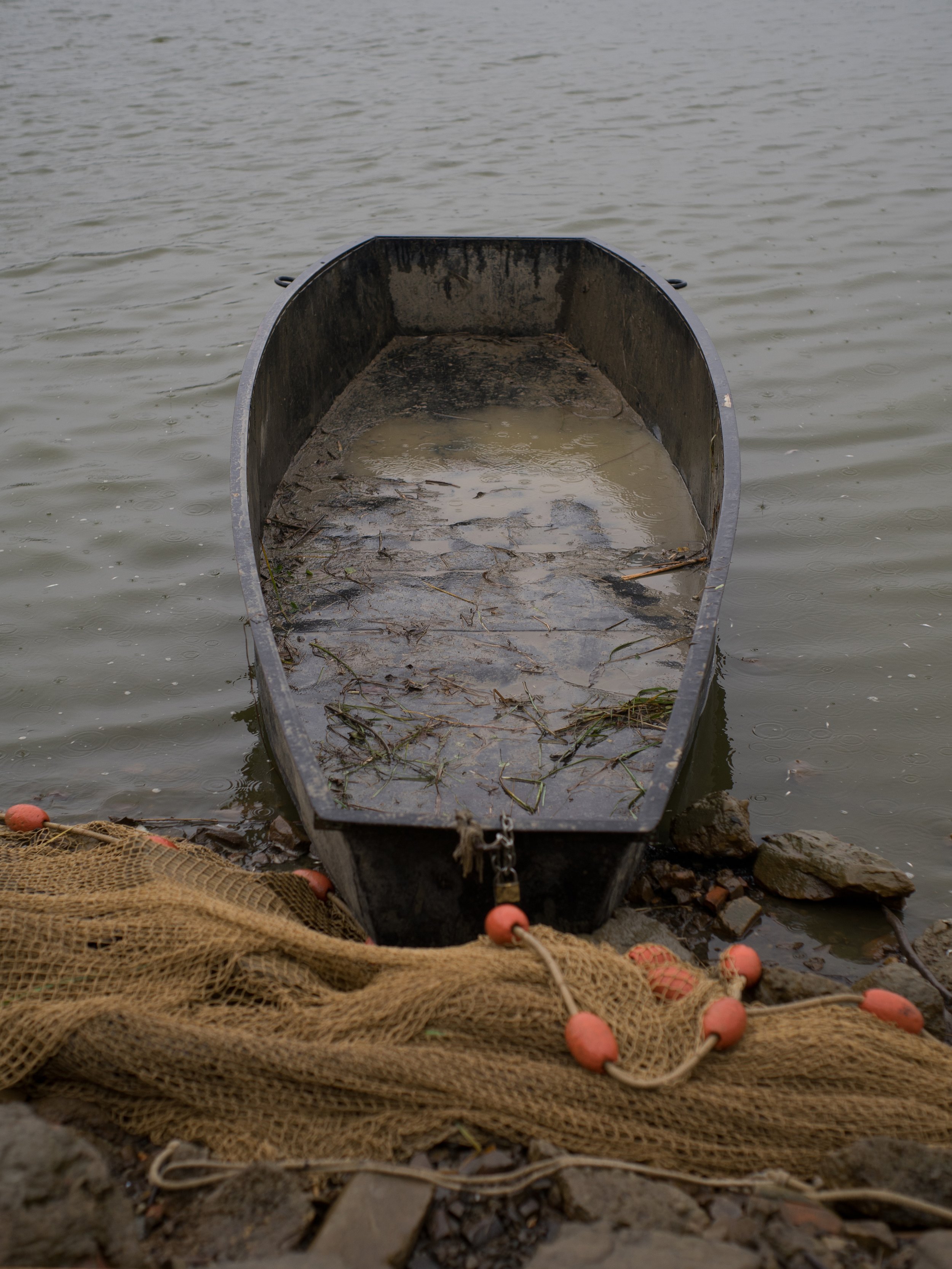  Hungary, Ladomány, 18 November 2022The last boat waiting to be towed ashoreAlthough it rained all the time during the fishing, József said it arrived late and the amount was insufficient. The streams that feed the lake dried up by the end of the sum