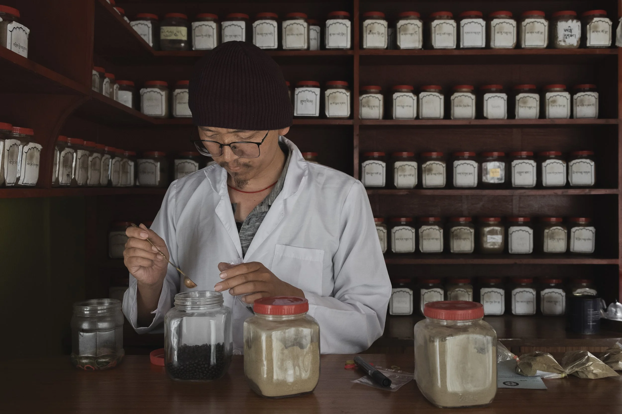 Amchi Khedup Loden Gurung packs Sowa Rigpa medicines in a clinic in Jomsom, Mustang. Photo by Yuri Segalerba.