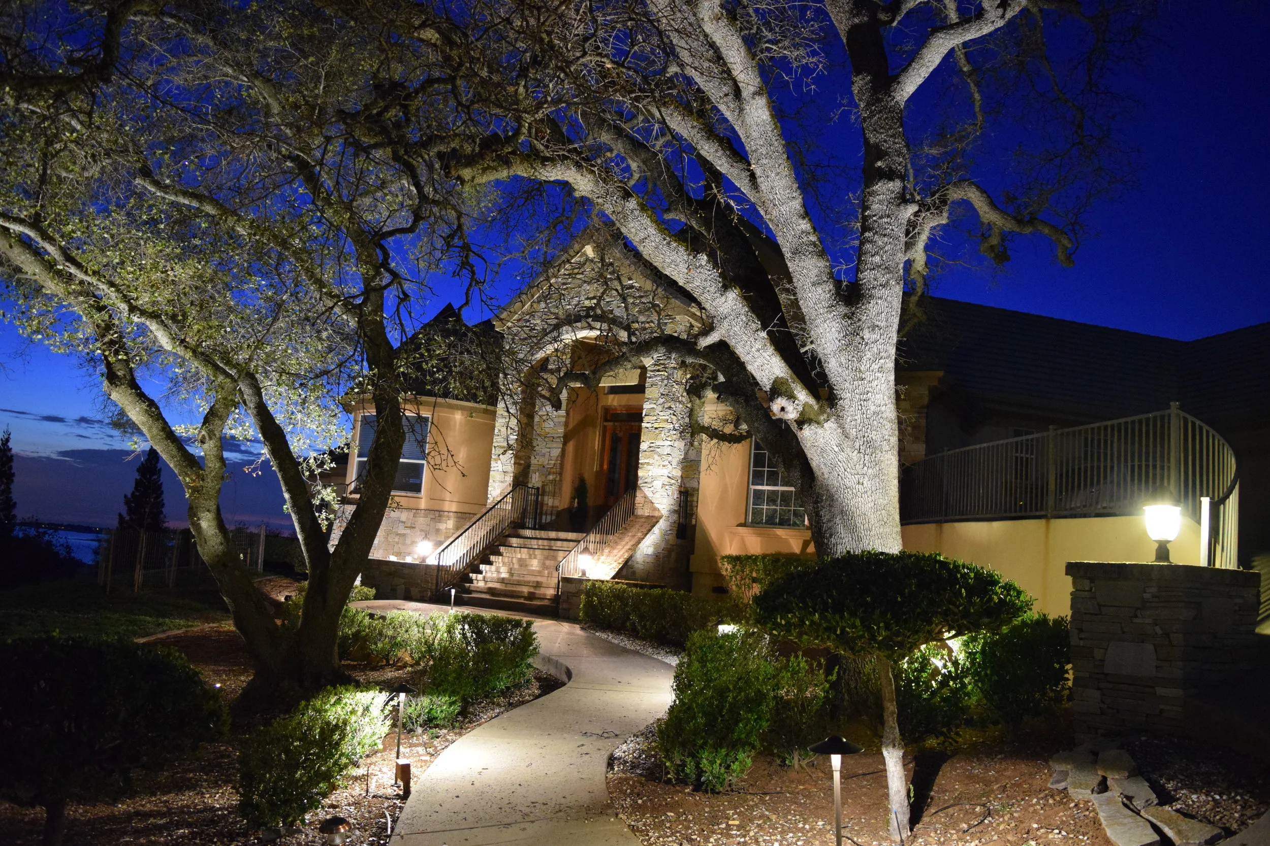 Landscape lighting shows the way to the entry to welcome guests