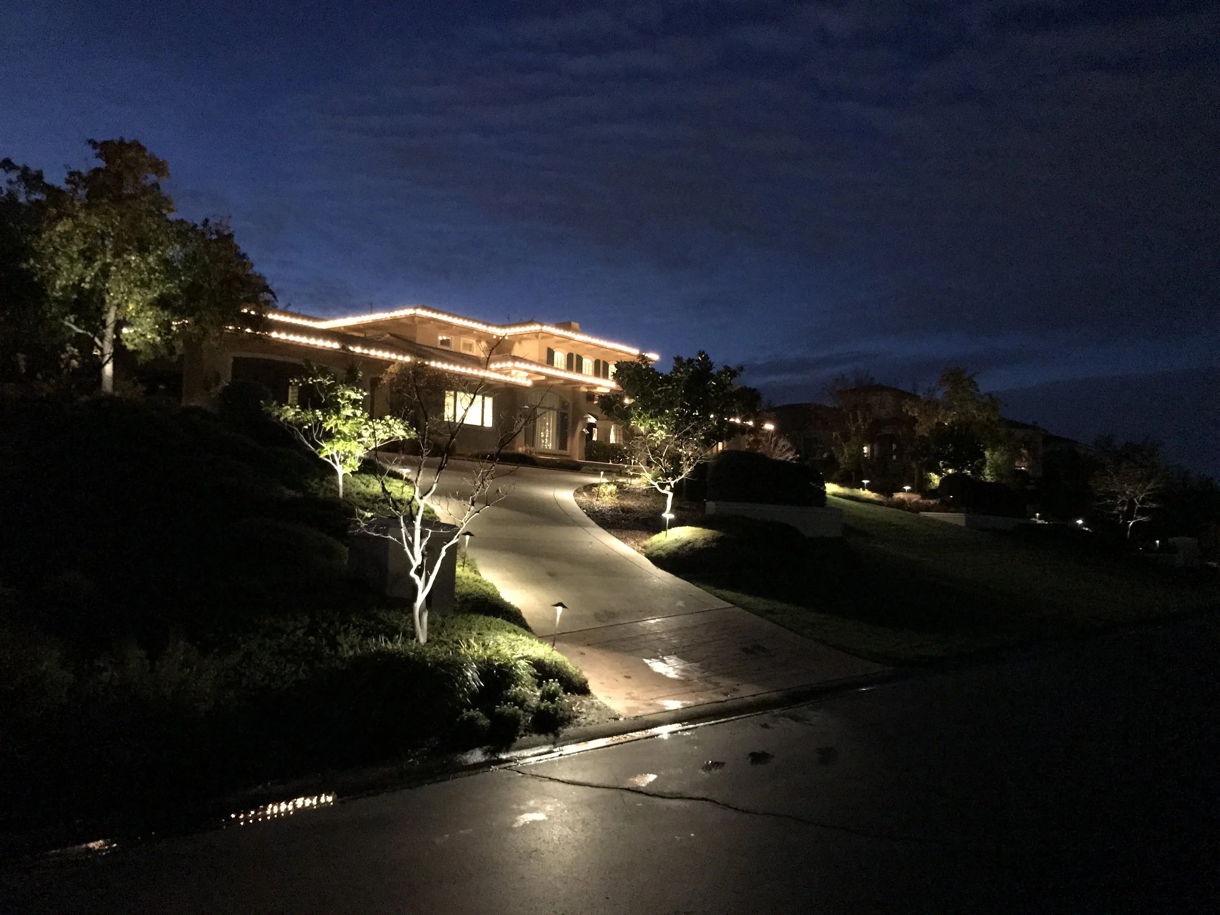 Area lights on the driveway create a scalloped pattern of light