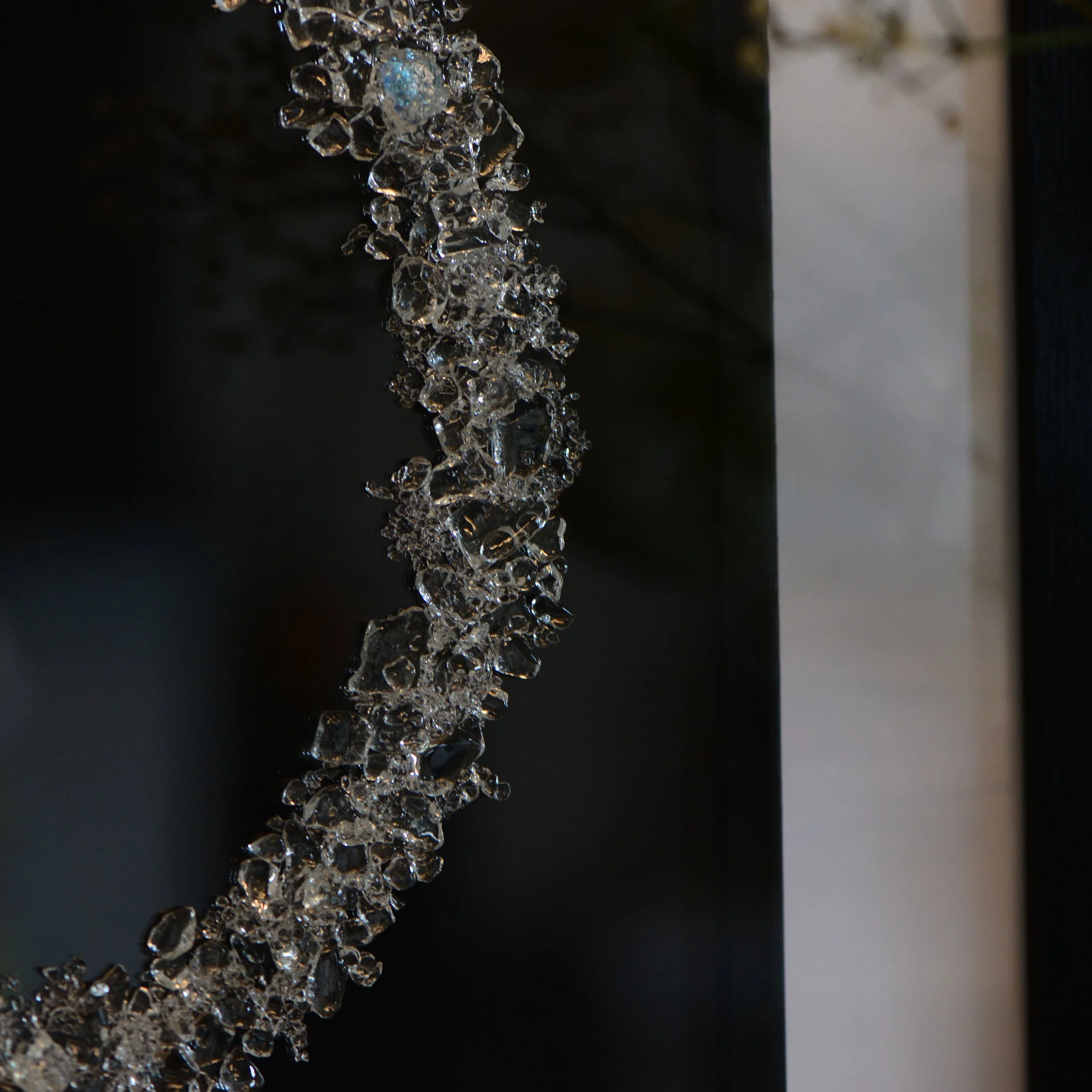Detail view of the beautiful crystal clear and dichroic glass Framed wall art by Naomi Jacques