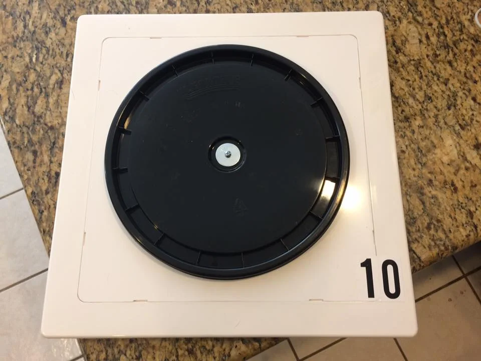 Another DIY approach we have seen is a 12" bucket lid stuck on a white plastic 14x14 access panel . Each of these are available at Home Depot, Lowe's, or your local hardware store.