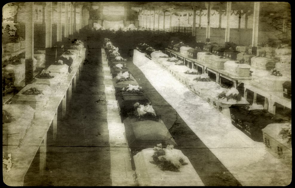 Rows of caskets belonging to the inmates who died in the fire