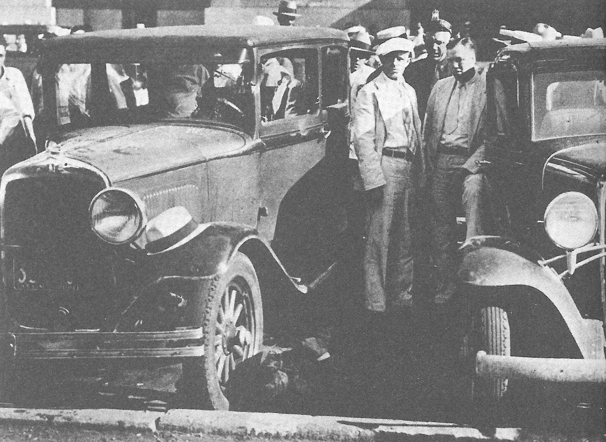 The bullet-riddled smoking ruins of the law enforcement car – with the bodies of the slain men still inside. 