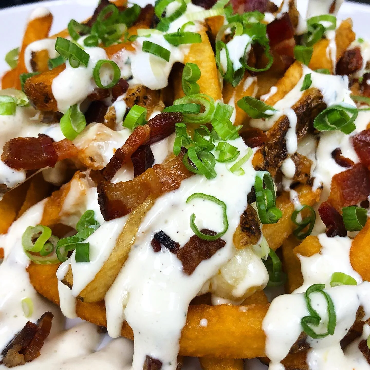 Loaded frites! Green garlic ranch, @bentonsbacon , cheddar cheese curds, scallions. We are open 12:30-9pm Saturday + Sunday for patio dine in, contactless to go and curbside pick up.