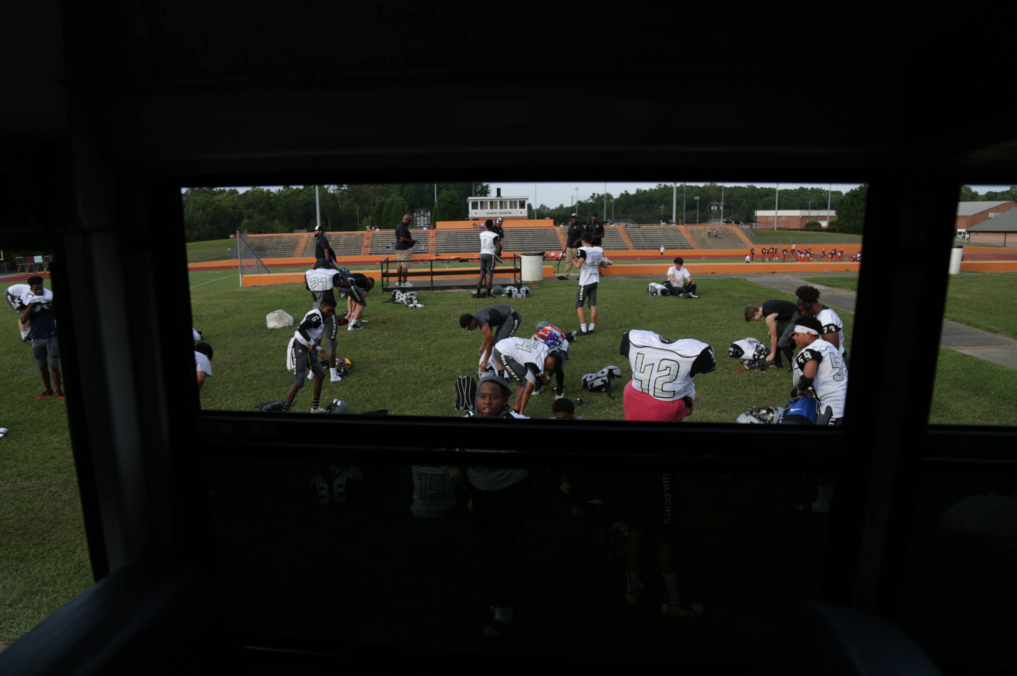 Players get ready outside of Orange High School’s football stadium. As a JV team, they don’t usually get into locker rooms, creating a bonding experience when they all put on their gear together outside. “We built a brotherhood this year and that’s really important. We played for each other,” said Jeffrey Monroe, a junior halfback.
