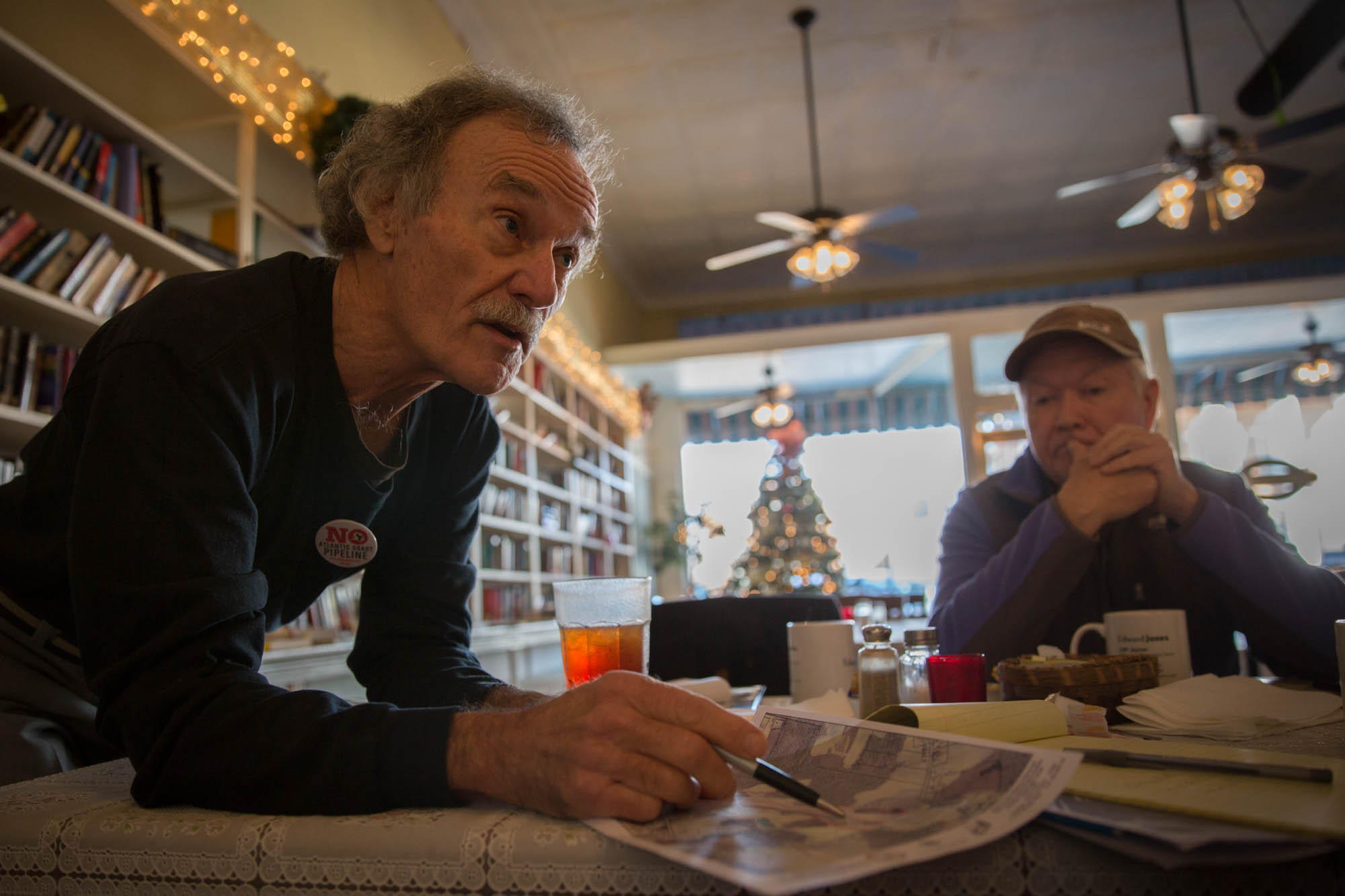 Winstead meets with other activists to discuss the best ways to get the pipeline stopped. He is showing a newcomer an aerial shot of his land, and points out where the pipeline will go. “There are many lies they’re telling people about it,” he says. “Once its there, it makes the land basically unfarmable.” When they put layers of rock down, it ruins the land for decades, and nothing can be built around it.