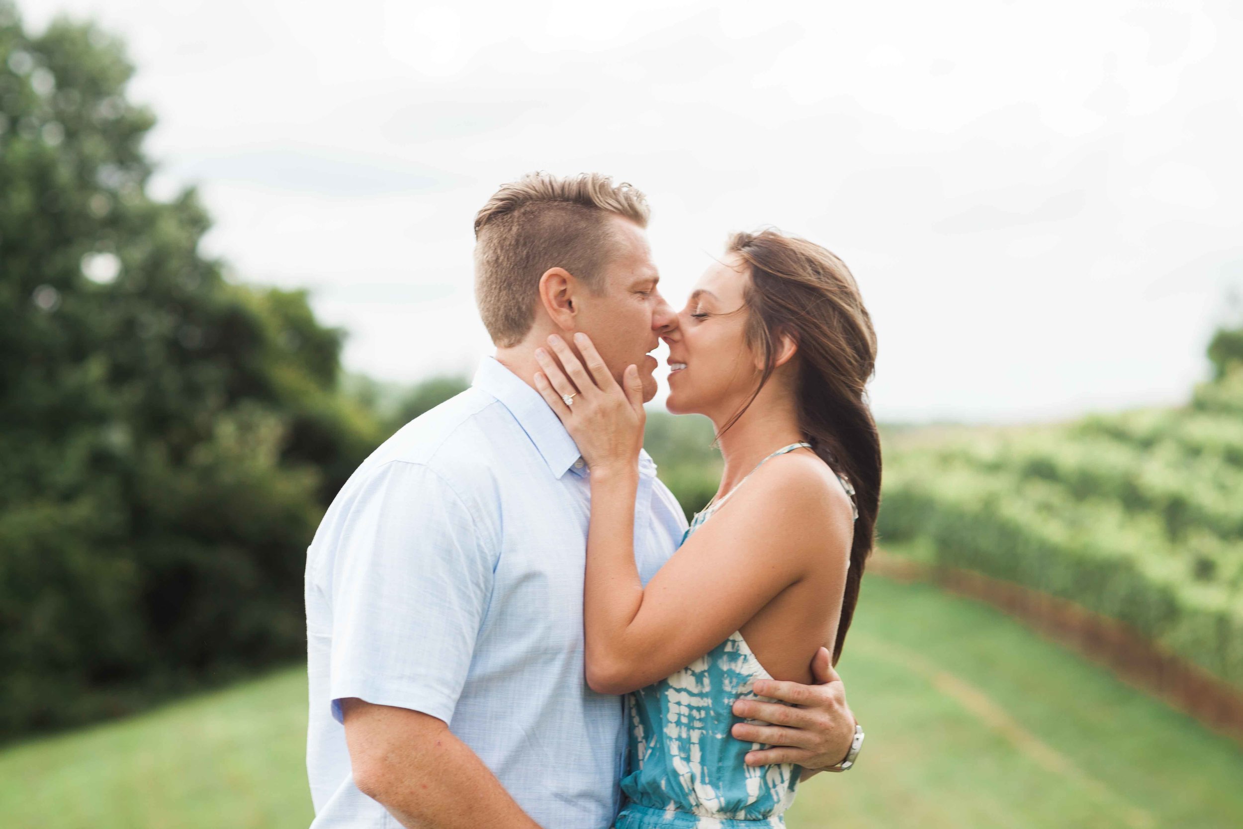 Engaged couple share kiss in north georgia vineyard