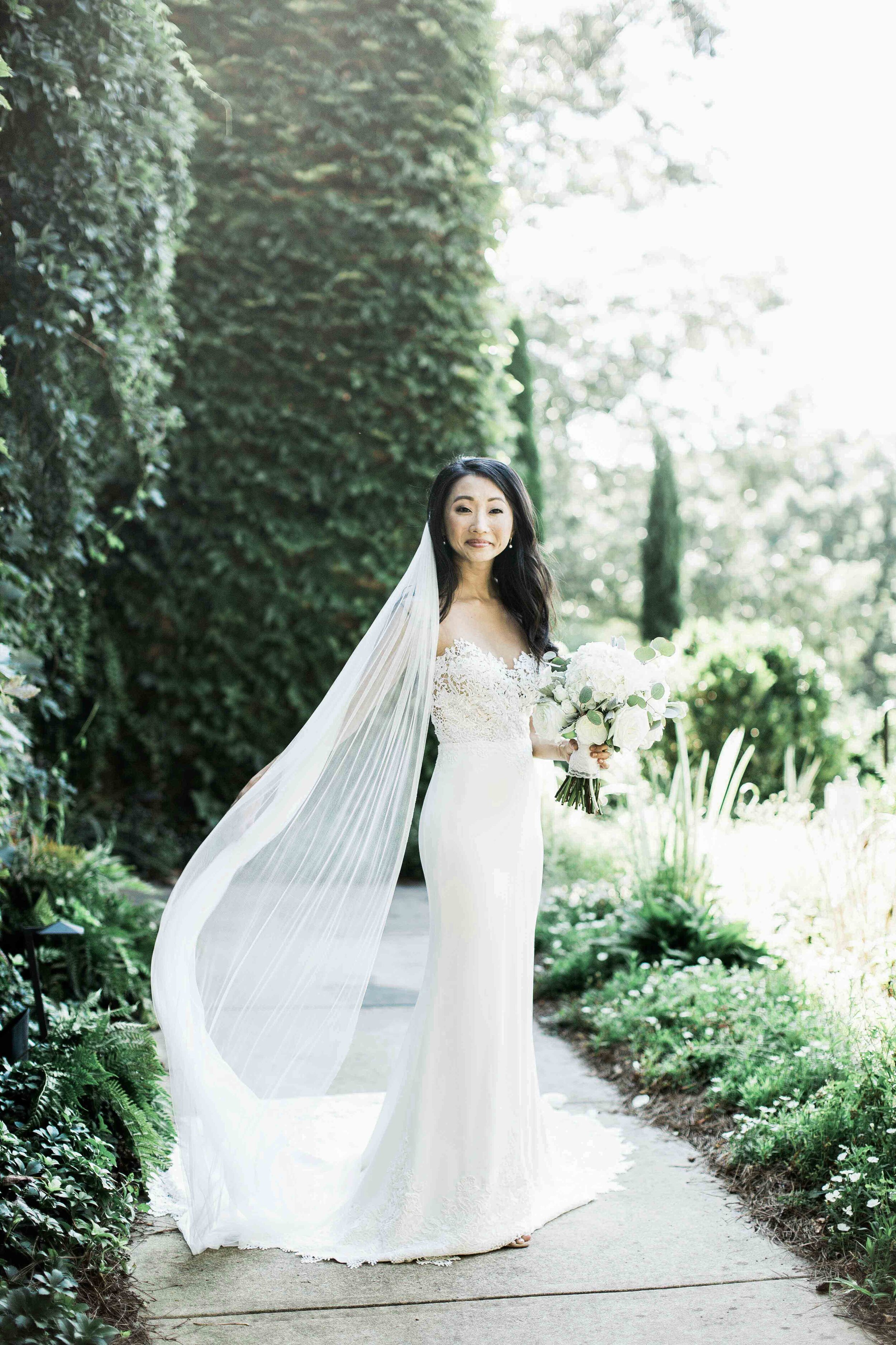 Bride with sheer veil and illusion front wedding dress