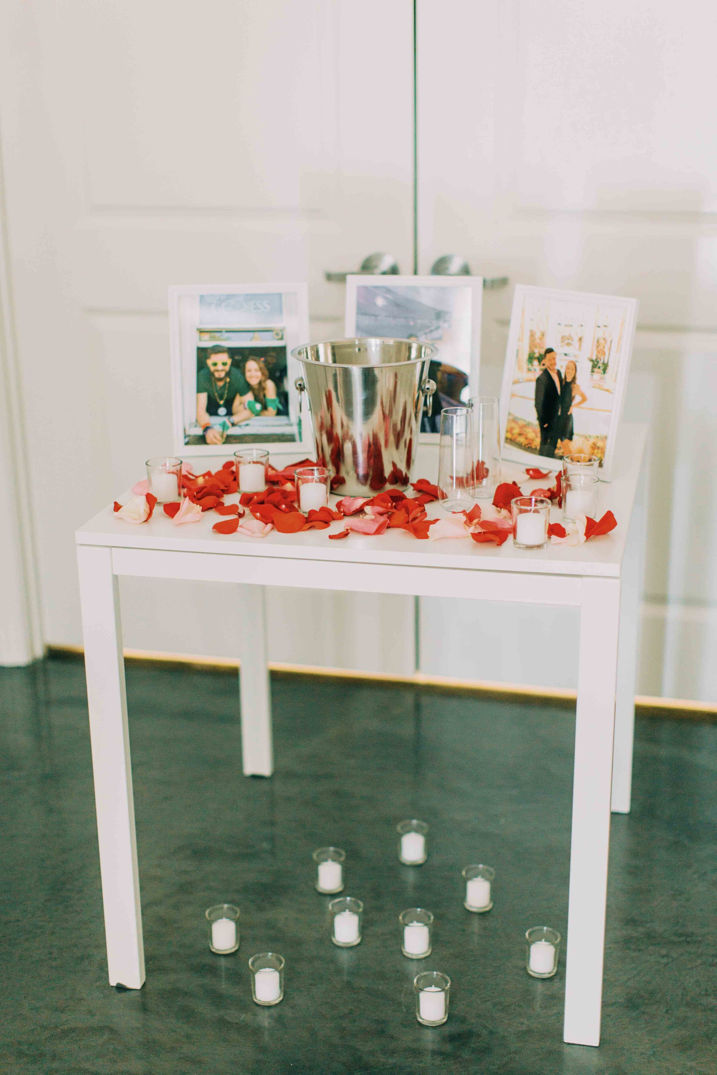 table display of memories in frames and romantic petals