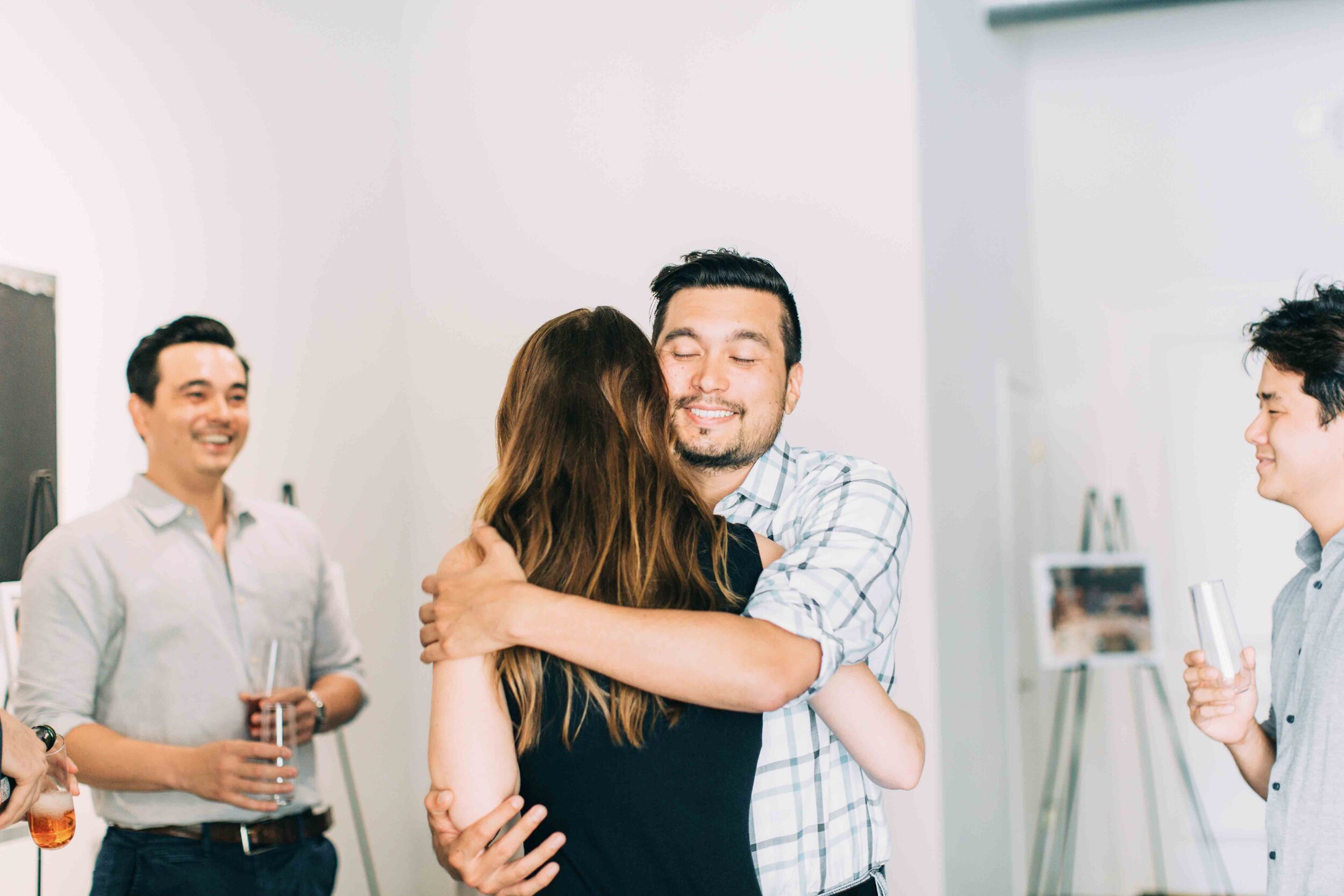 Bride shares hugs with friends at engagement party