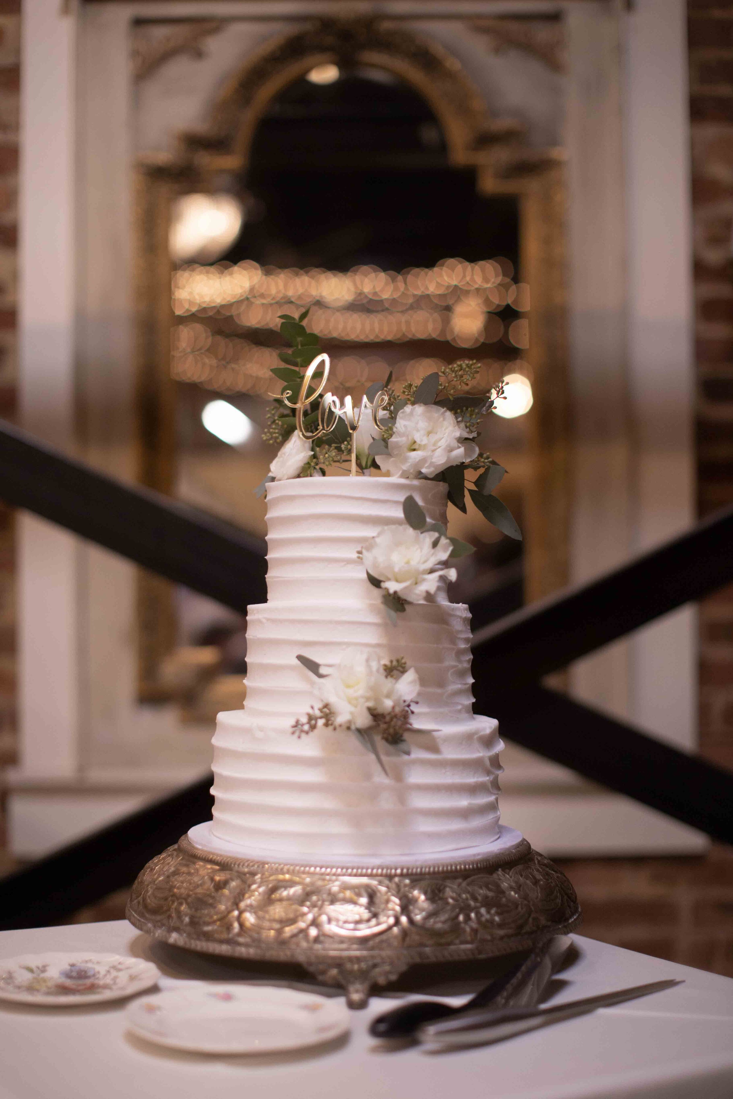 classic white wedding cake with white florals 