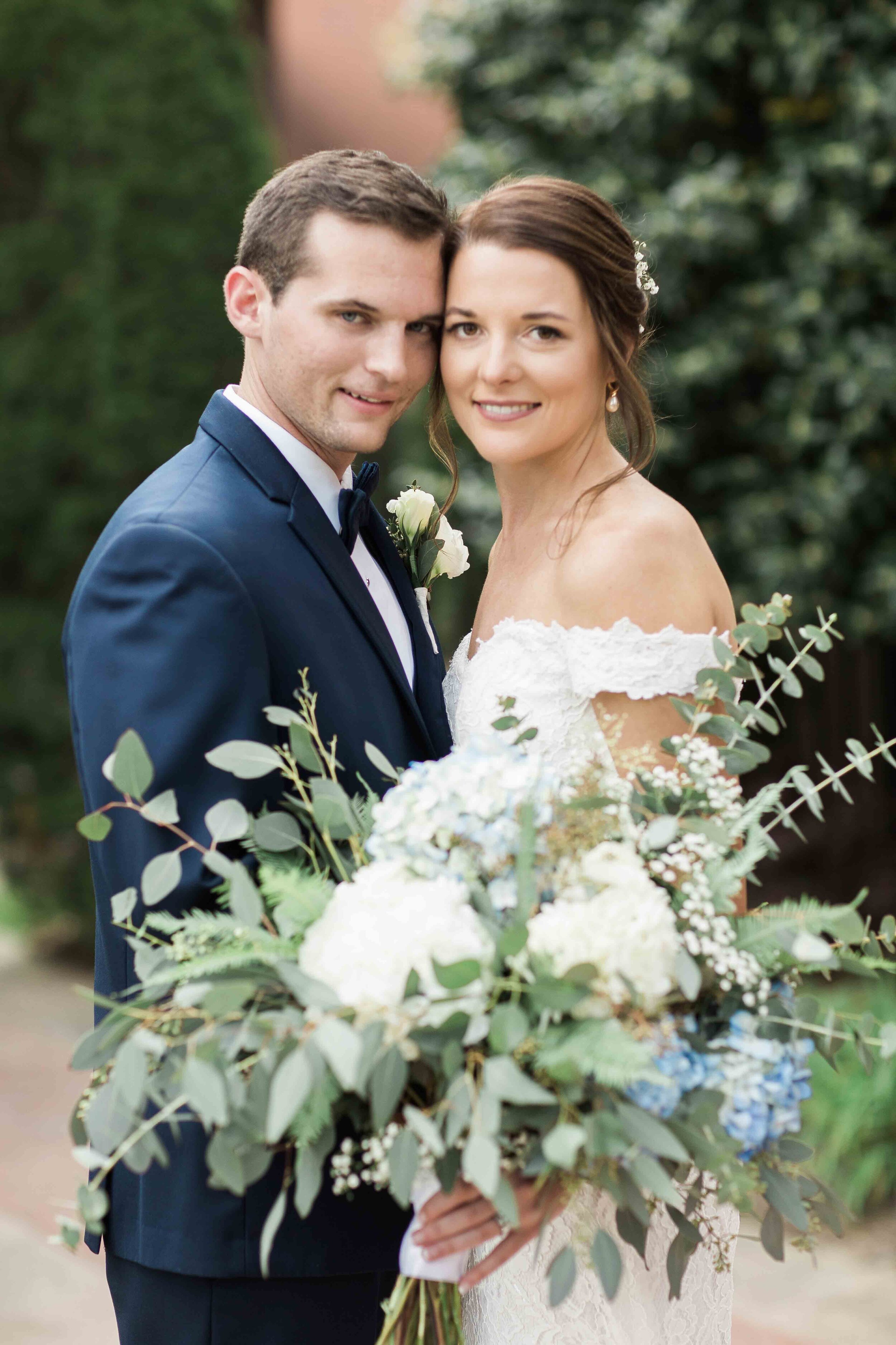 Roswell Historic Cottage bride and groom with large blue and white bouquet