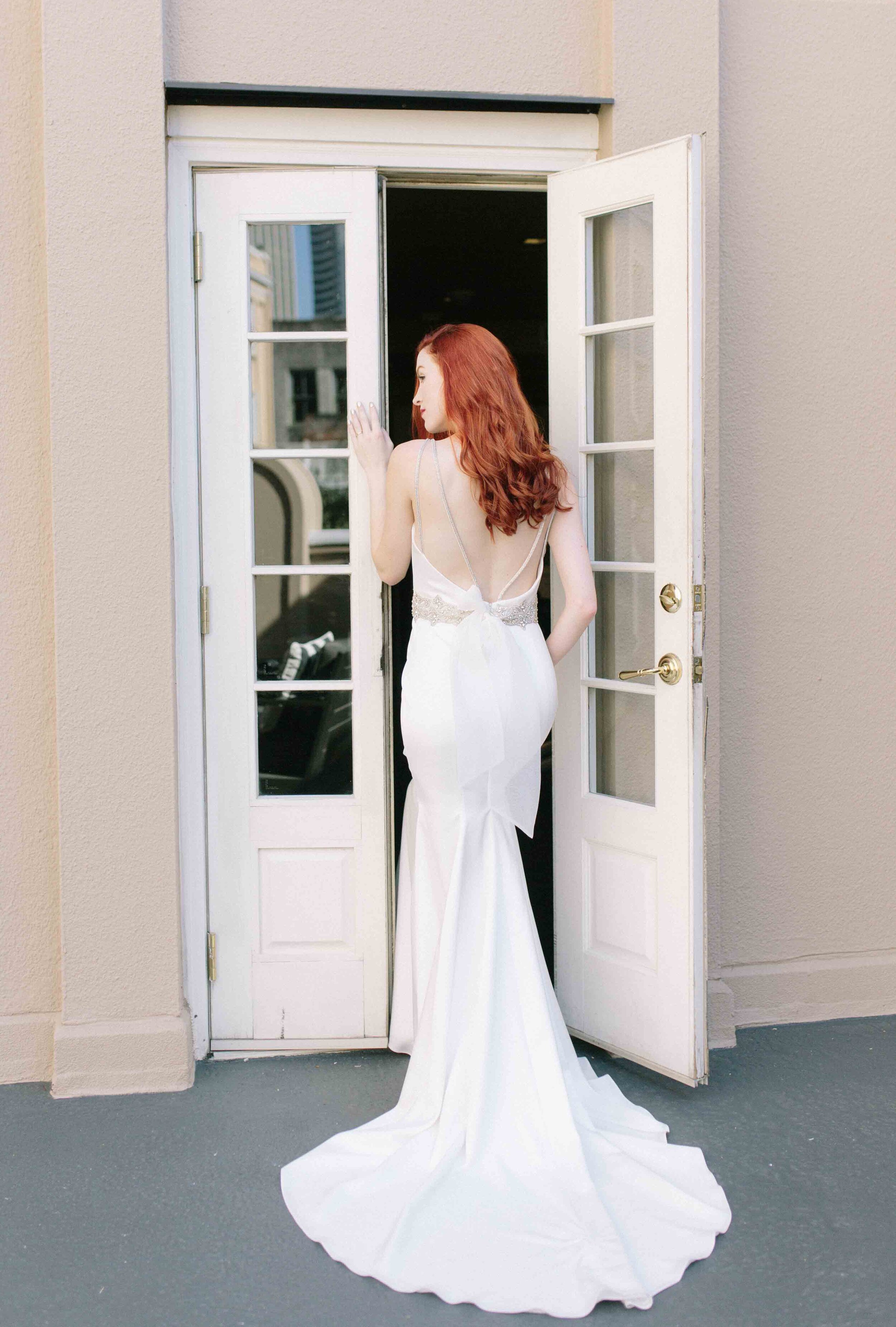 Down style hair with low back wedding dress