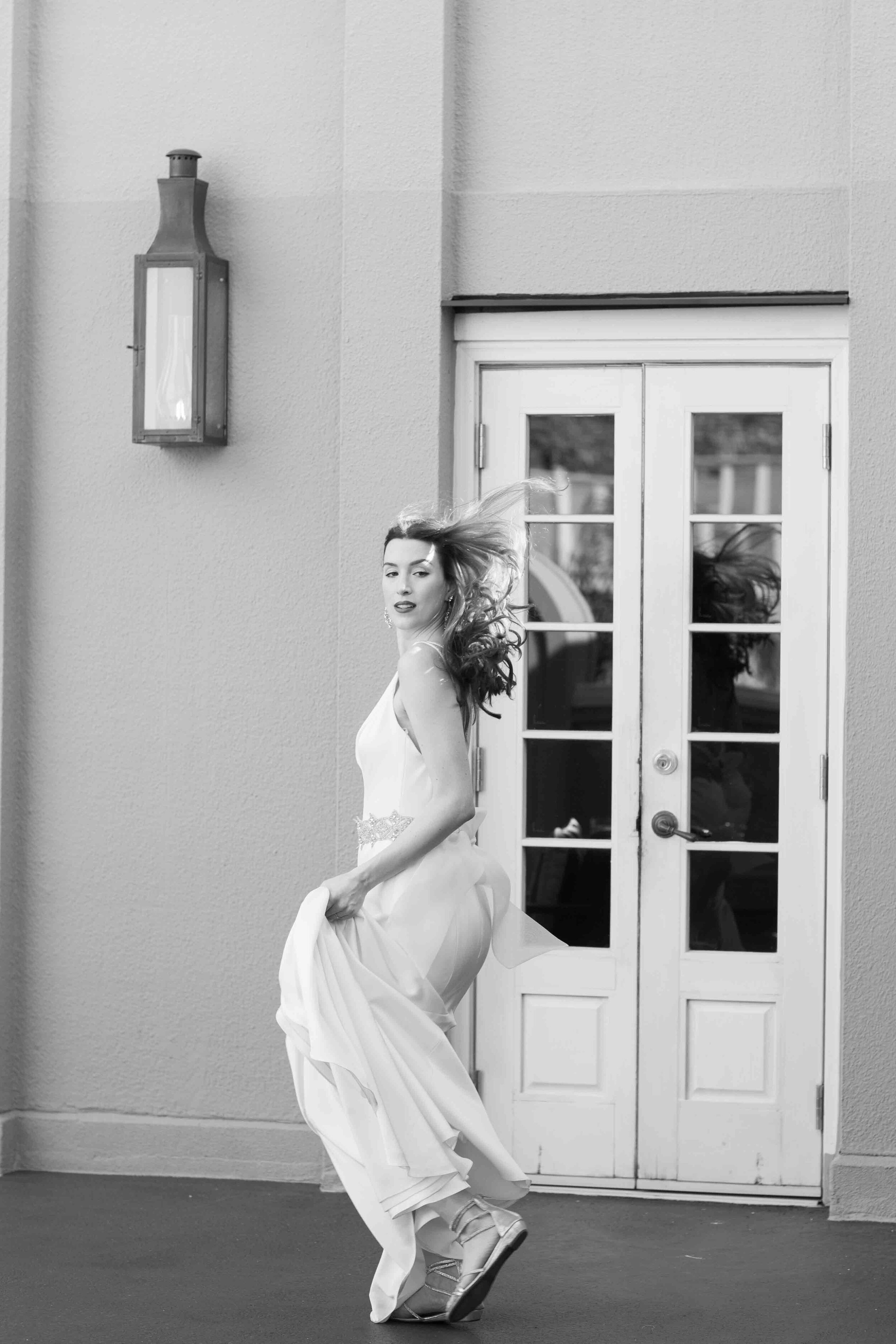 whimsical bride dancing in her gown with the wind in her hair