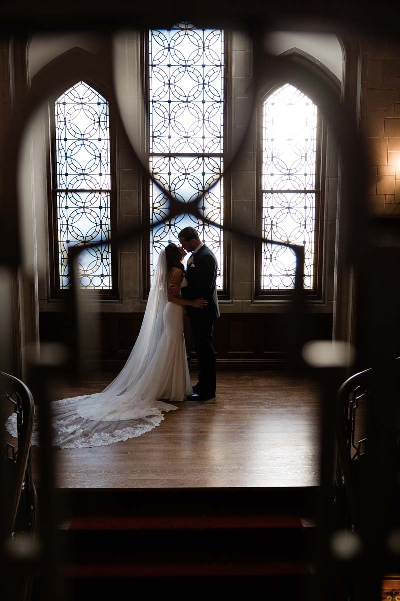 Callanwolde Fine Art Center Wedding-Poetry and Paper- Dawn Johnson-timeless-classic--bride and groom kiss stained glass.jpg