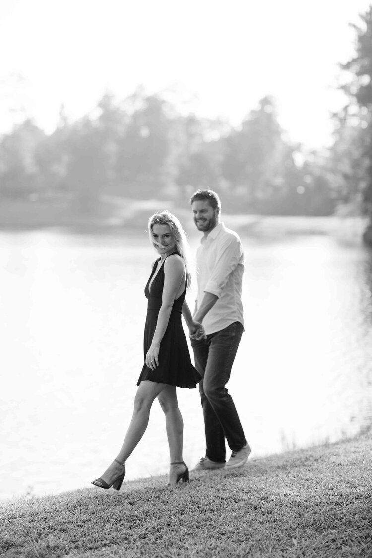 Engagement Photographer- Poetry and Paper- Dawn Johnson- black and white, couple walking near lake.jpg