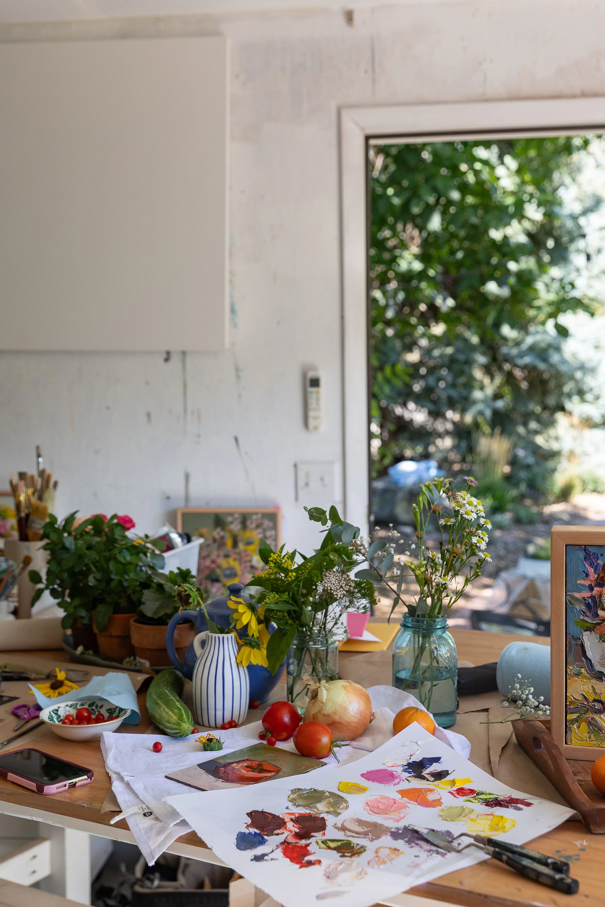 still life oil painters studio with paints, fruits, vegetables, and flowers
