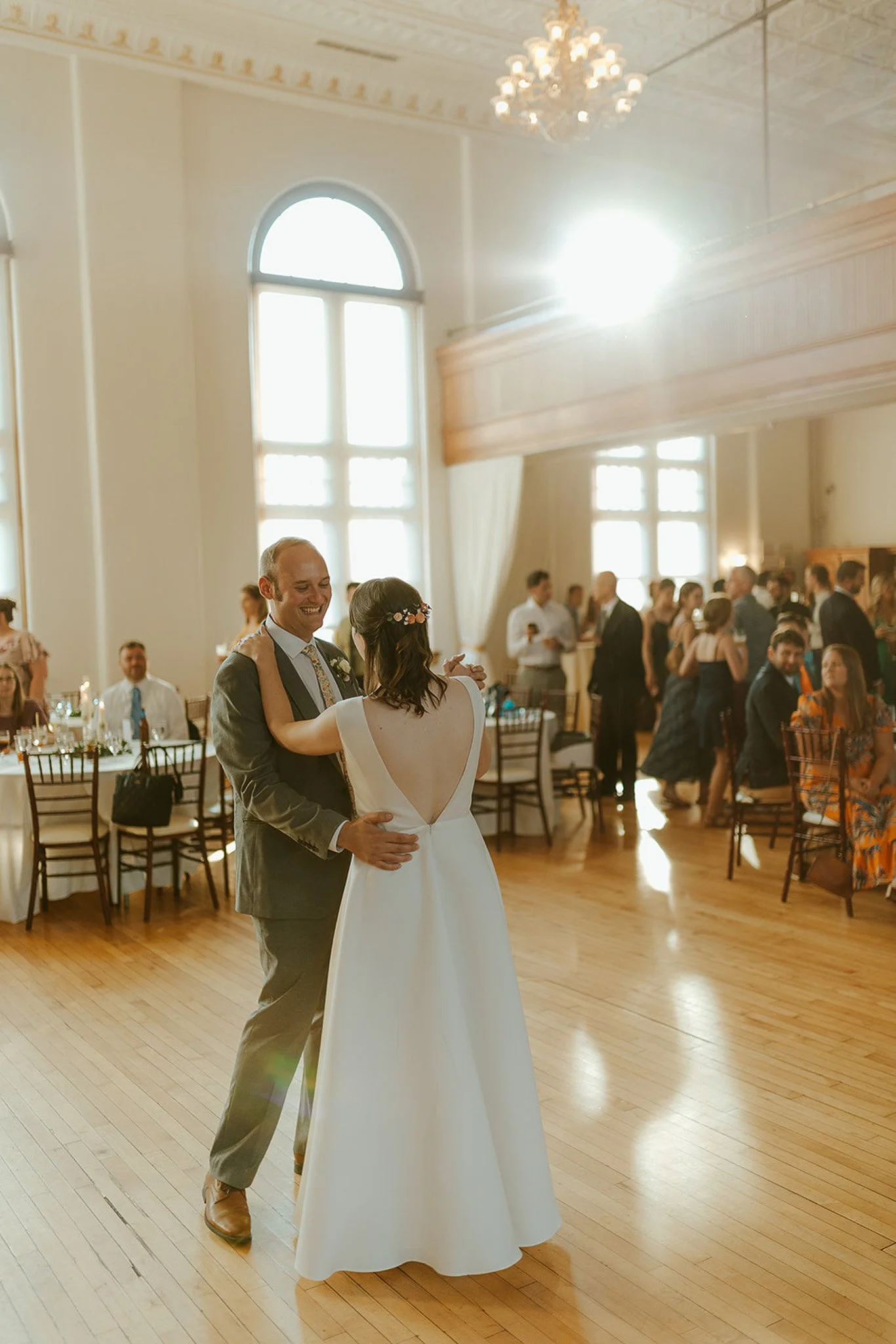 Bride and Groom Dance in Elegant Ballroom Lighting.jpg