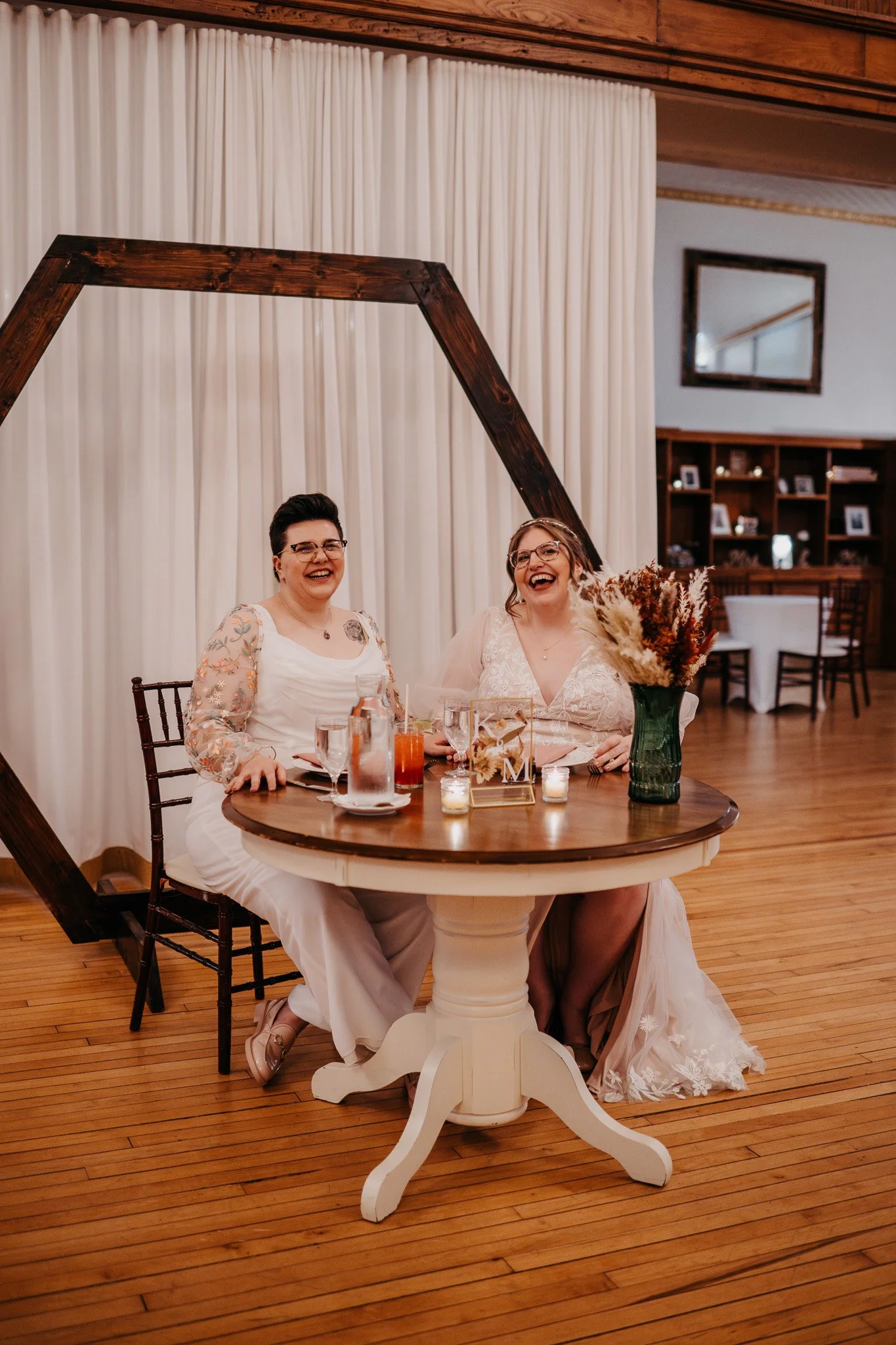 Brides Laughing at Sweetheart Table.jpg