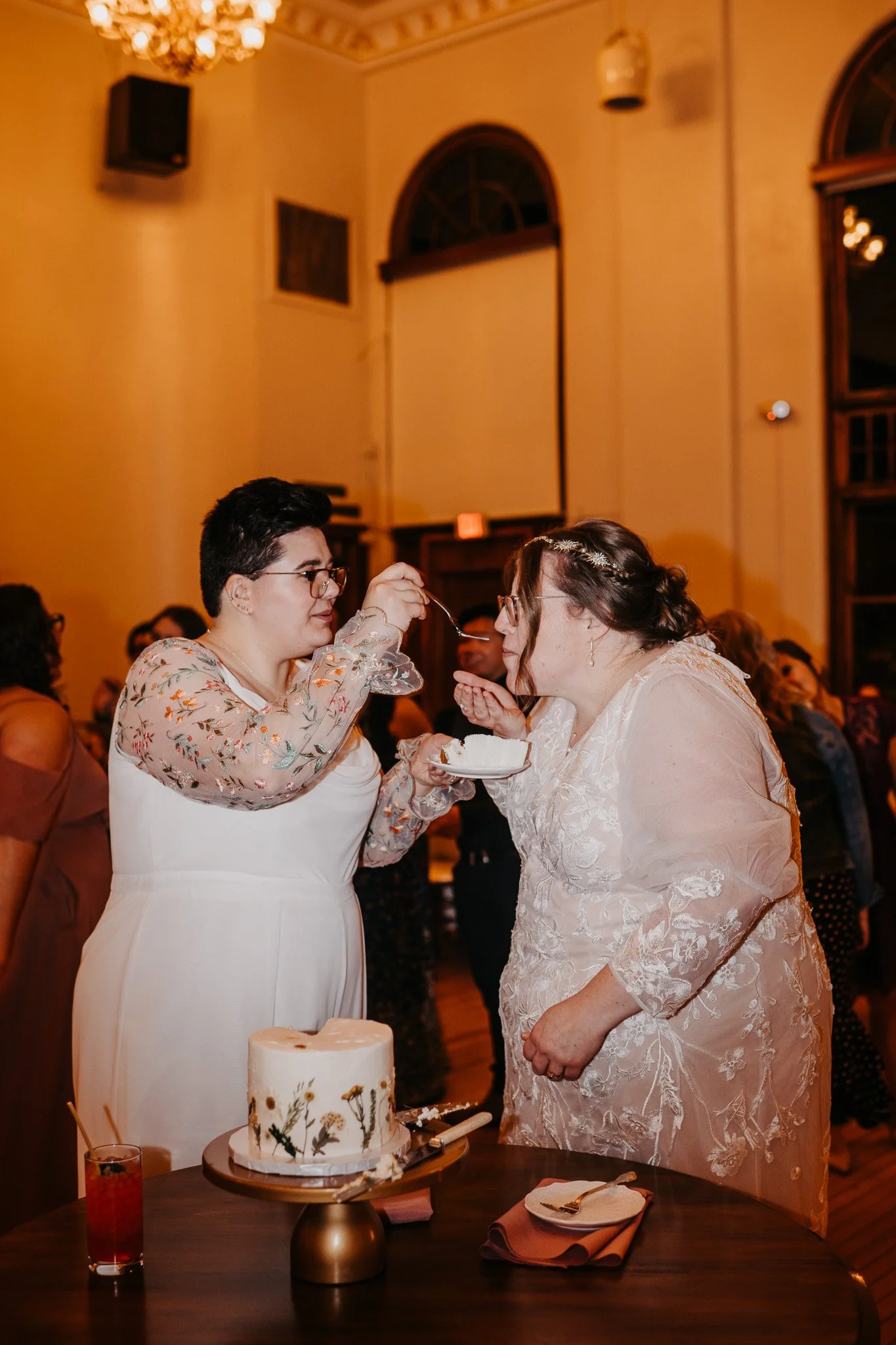Brides Feeding Cake to Each Other.jpg