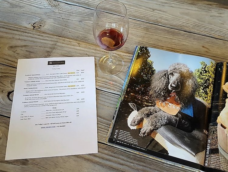 Treasure Island Wines' tasting menu and a page from a book on vineyard dogs.