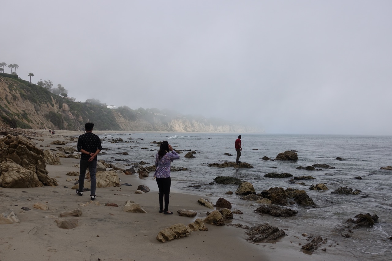  Haim Abadi, 38, explores the tide pools as his family looks on. 