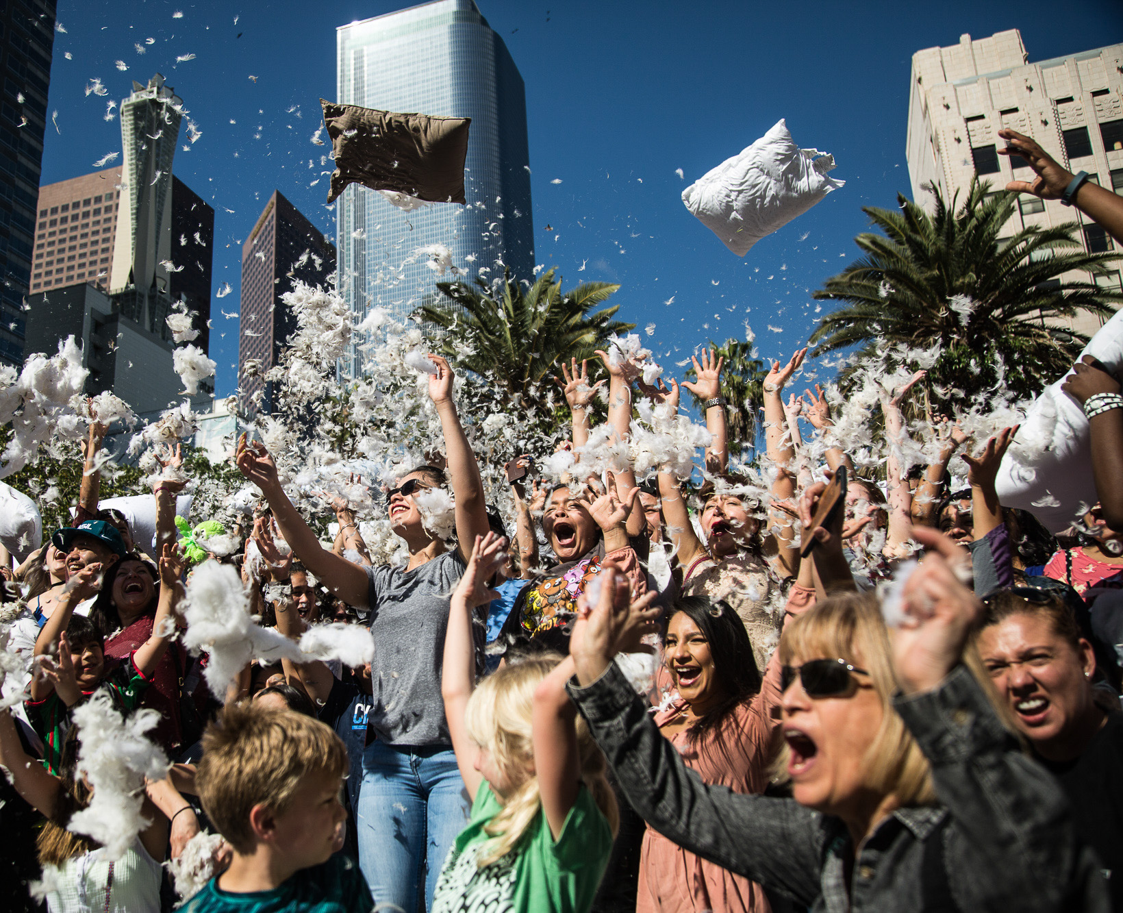  Participants of the International Pillow Fight Day cheer and scream while throwing pillows and feathers in the air in Pershing Square in Downtown Los Angles on Saturday, April 1 2017. Hundreds of people traded soft blows in a giant pillow fight that