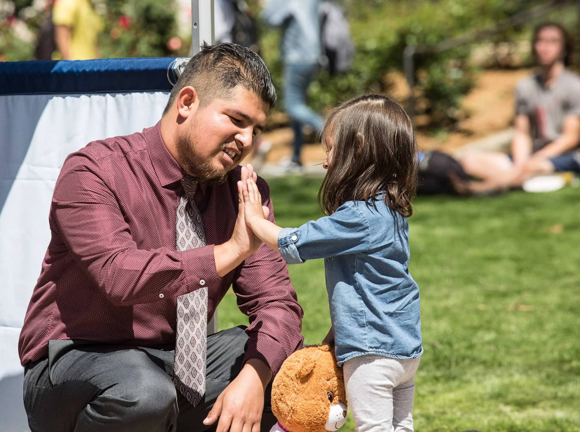President of the Home Boys and Home Girls Club Edgar Mauricio Gonzalez gets a high five from his daughter after campaigning for Associated Student (A.S.) Vice President during the A.S. debate which took place at the clock tower quad in Santa Monica Community College in Santa Monica Calif., on Tuesday, March 28, 2017. Gonzalez was announced as the A.S. Vice President on Friday, April 7, 2017. (Photo by Matthew Martin)