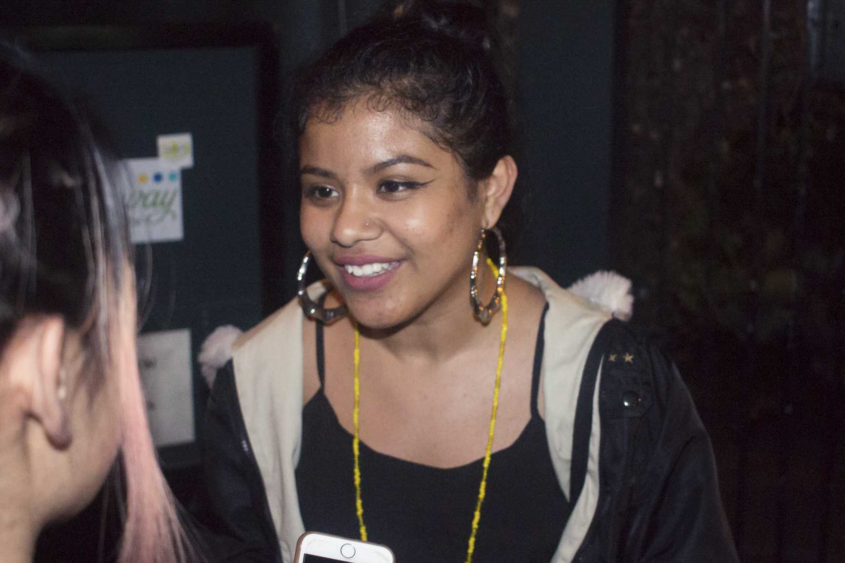  One of the younger performers on Tuesday night March 14th, 2017,  at Da Poetry Lounge, was 18 year old La Morenita. She meets to talk to people and fellow poets after the first half of the show. Los Angeles, Ca. (Photo: Jazz Shademan) 
