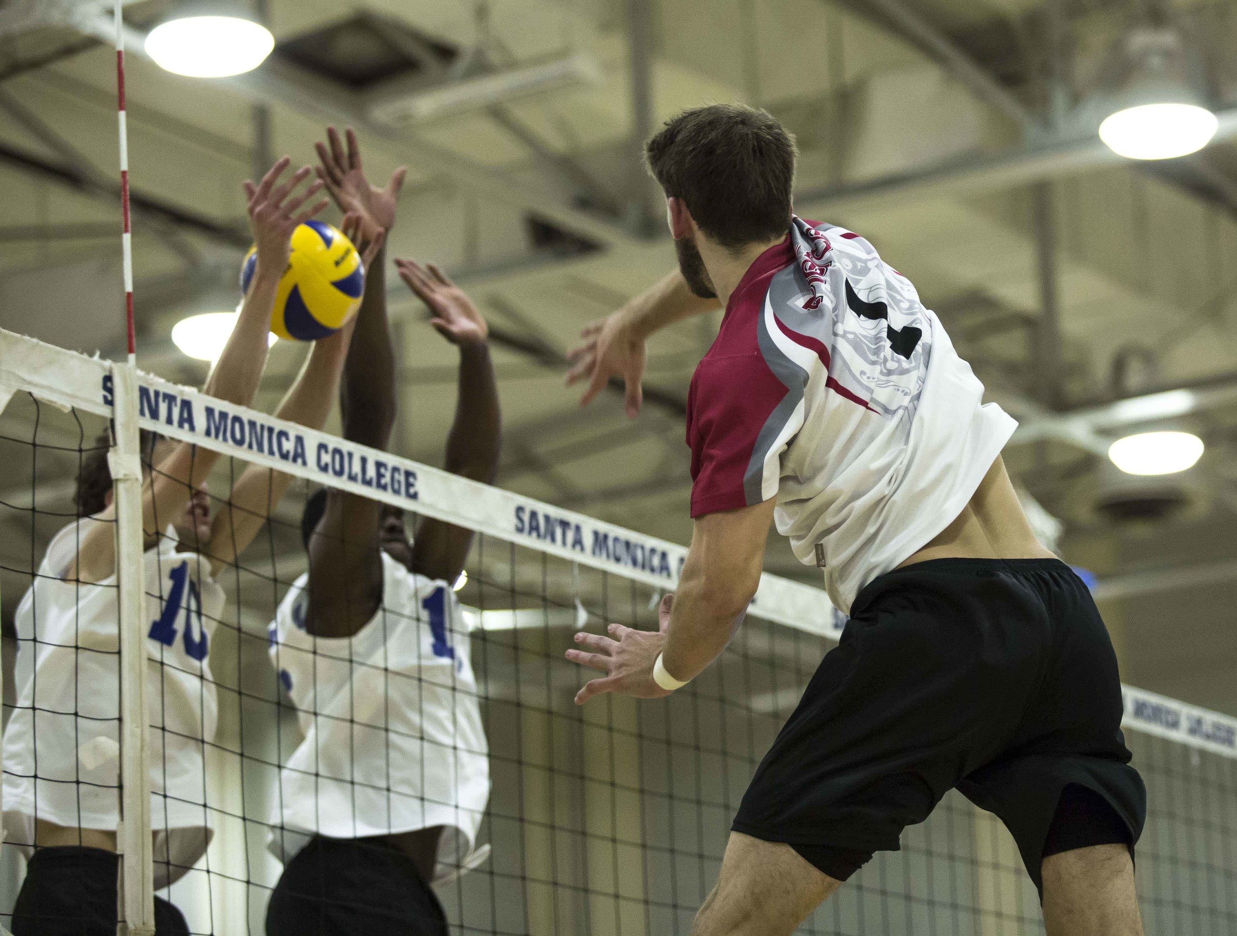  The Santa Monica Corsair defenders attempt to block the incoming spike by Pierce College Brahmas freshman opposite hitter Brandon Oswald (1, right) in the Santa Monica College gymnasium in Santa Monica Calif., on Wednesday March 1 2017. The Corsairs