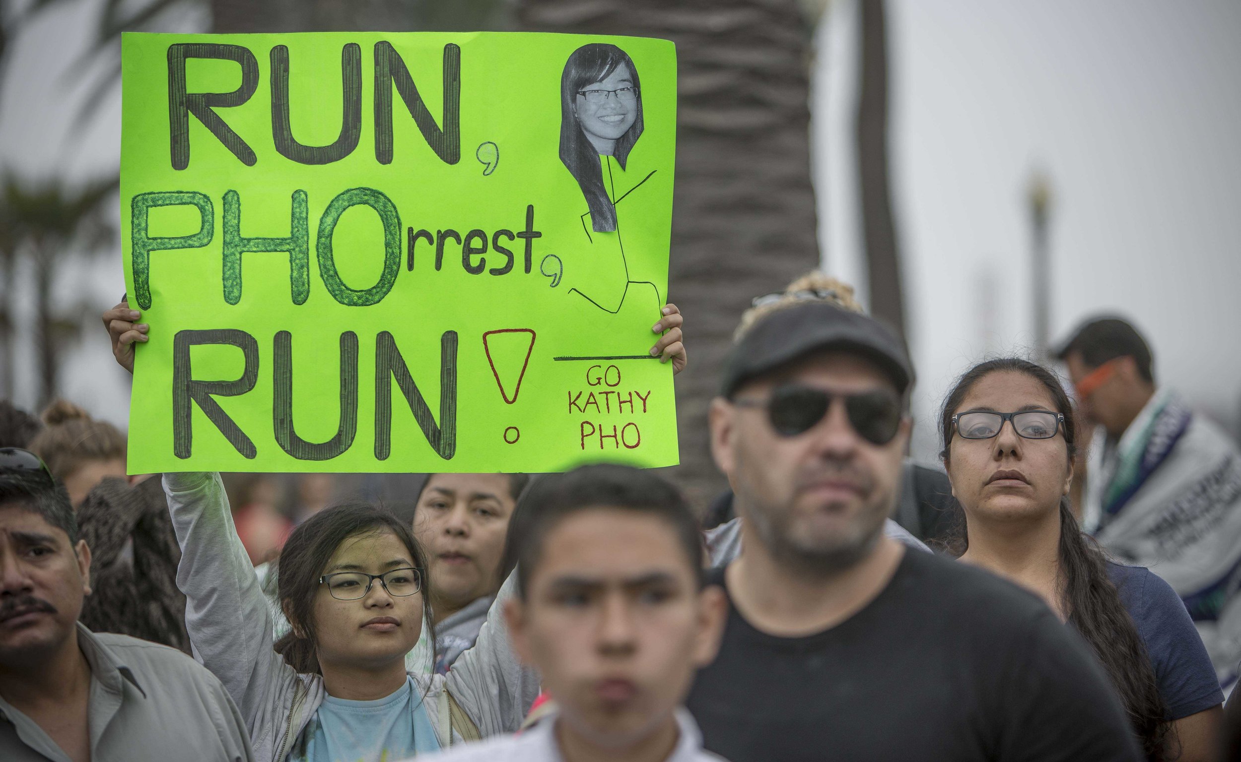  March 19, 2017. Katrina Pho holds up a sign waiting for her sister Kathy Pho to cross the finish line during the LA Marathon in Santa Monica, California. Daniel Bowyer 