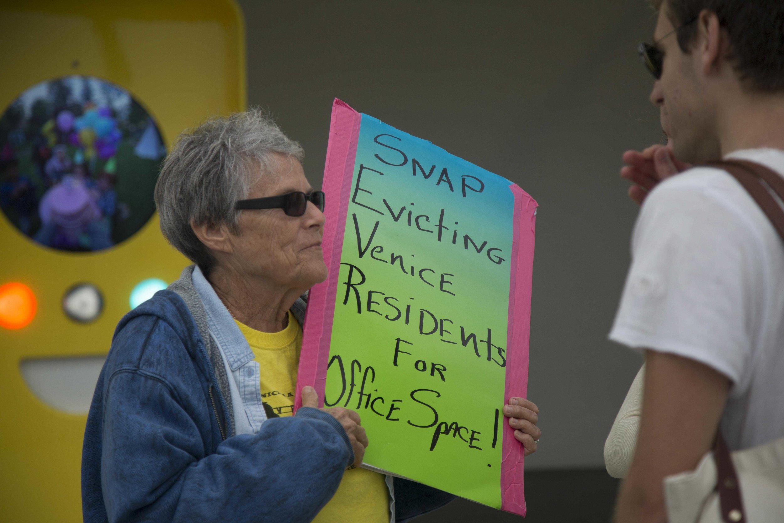  Retired social worker and Venice activist Linda Laisure explains to a young couple her problem with Snapchats presence in Venice and its newly opened storefront, Spectacles at 701 Ocean Front Walk, Venice, Calif., on Saturday March 11 2017. (Corsair