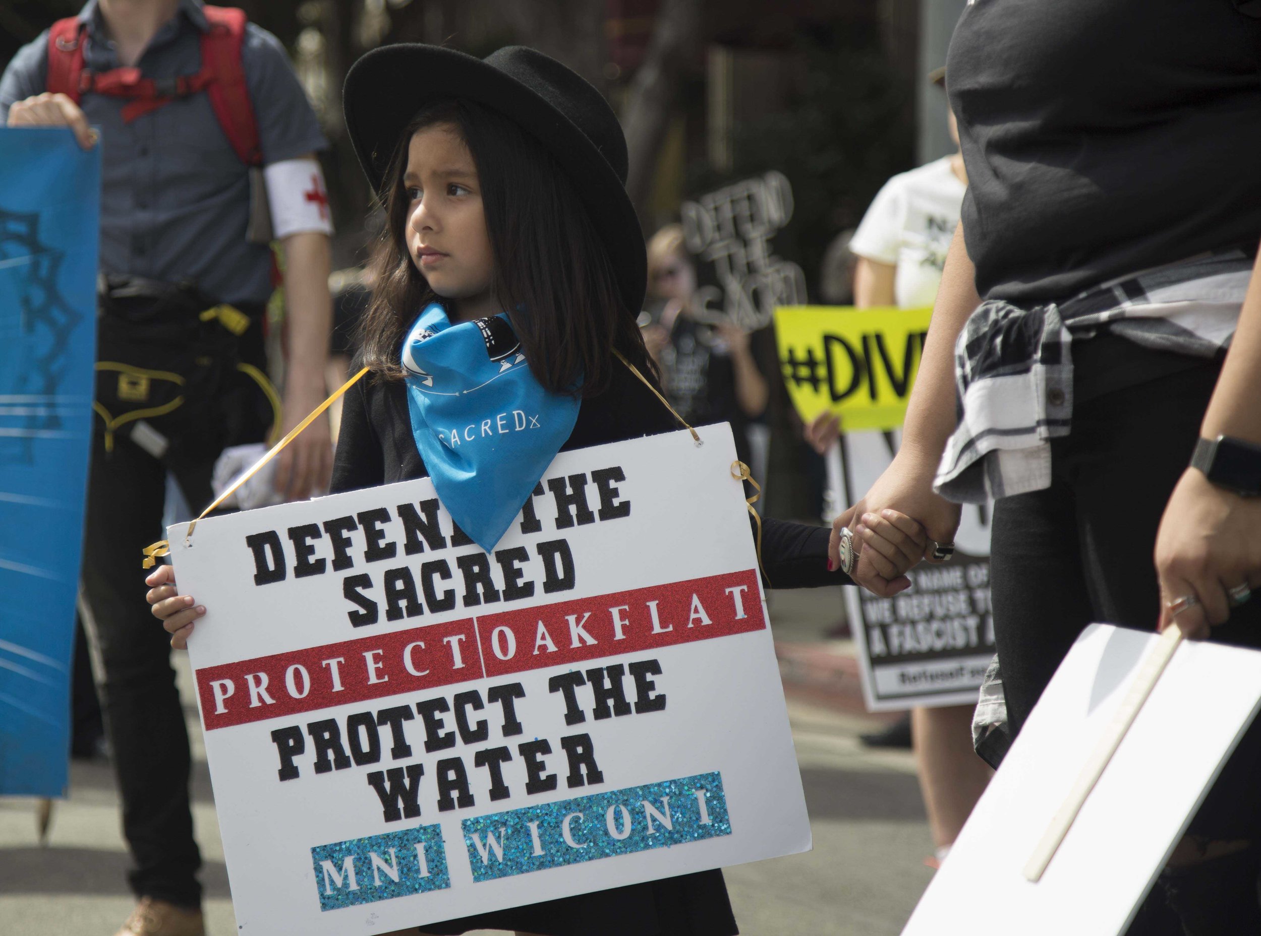  A young activist anxiously holds her mothers hand as the Divest LA march is about to begin in Pershing Square in Downtown Los Angles, Calif., on Friday March 10 2017. (Corsair Photo: Matthew Martin) 