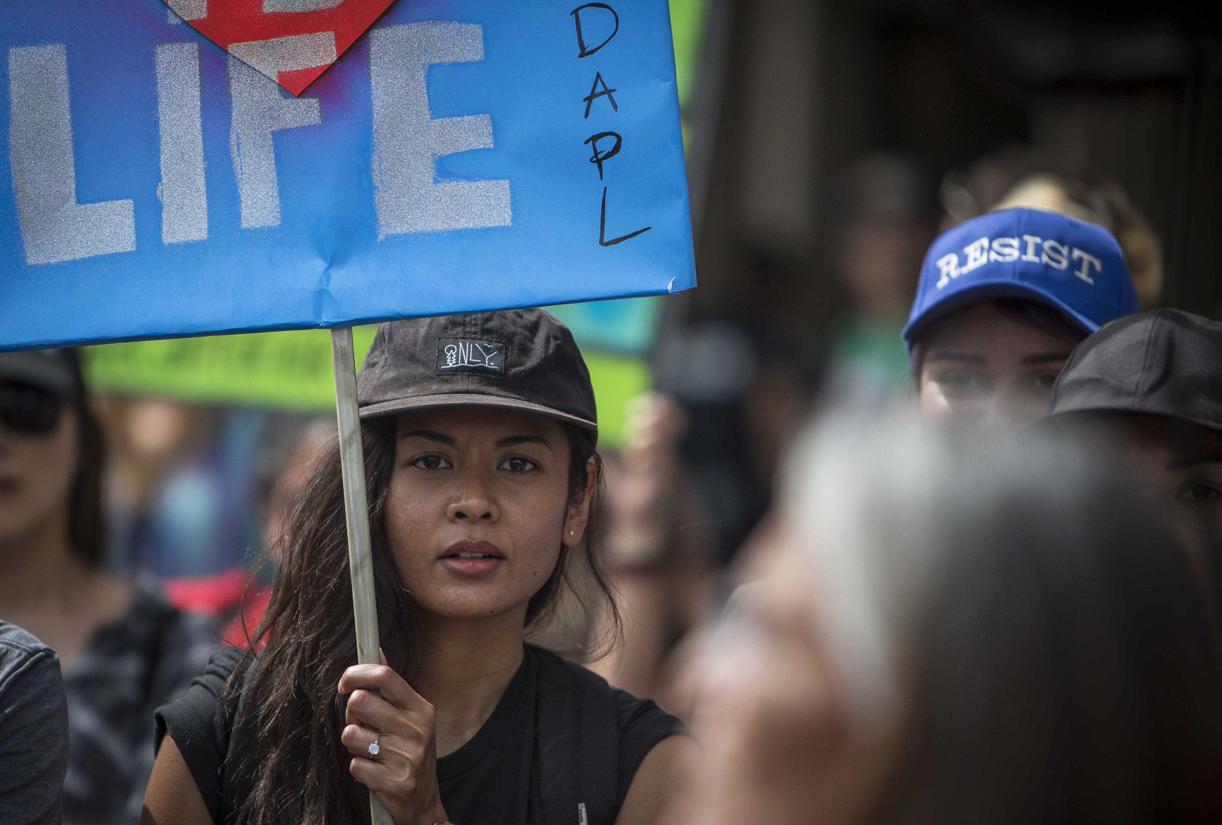  An protester holdind a sign about the Dakota Access  Pipeline prepaing to march from Pershing Square to City Hall in Downtown Los Angles, Calif., on Friday March 10, 2017.  Photo by: Daniel/Corsair Staff 