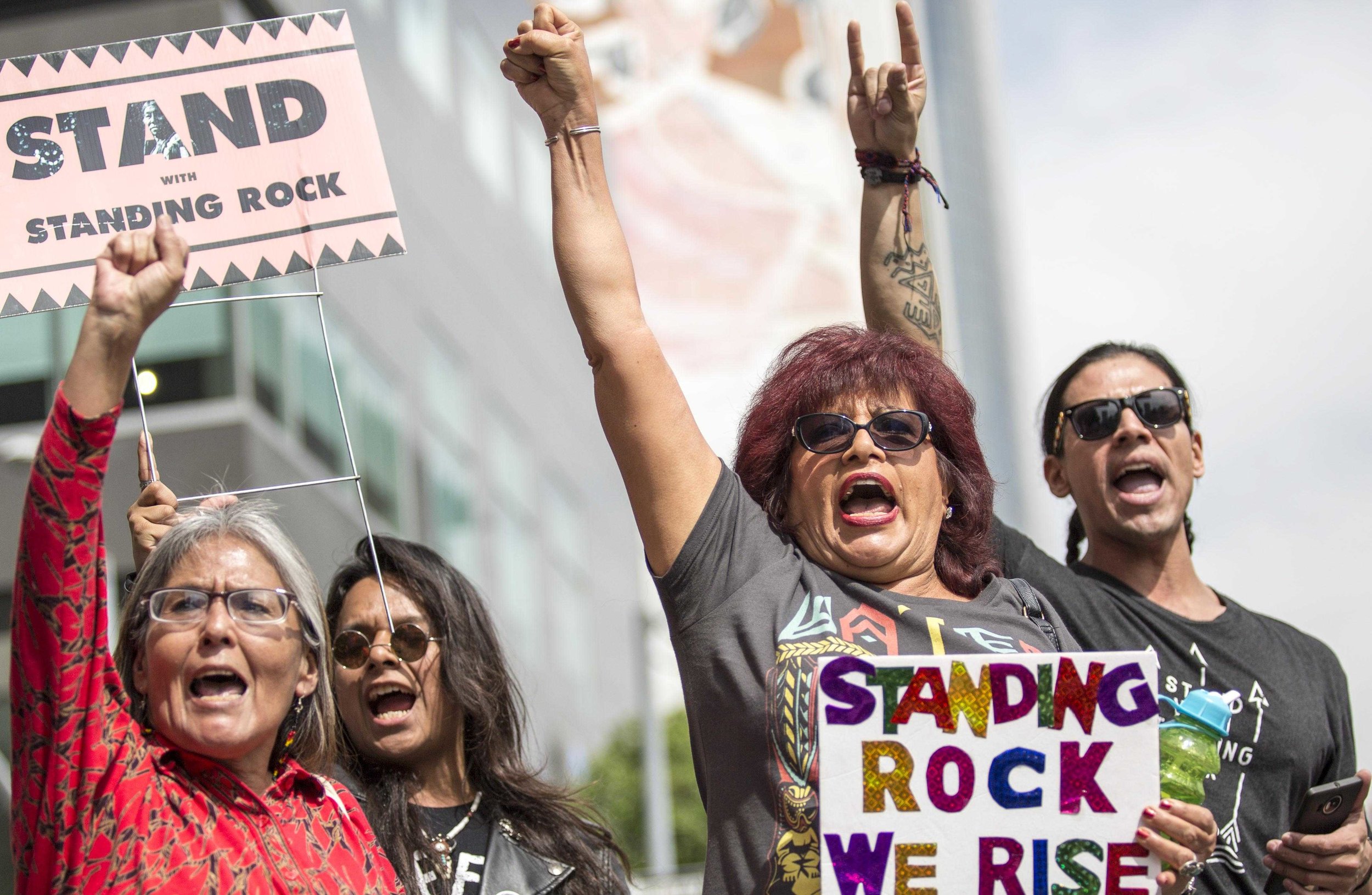  Divest LA protestors put their fists in the air in solidarity with standing rock and Defunding the Dakota Access Pipeline in downtown Los Angles, California., on Friday, March 10 2017. The Divest LA demonstrators are calling on the city of Los Angel