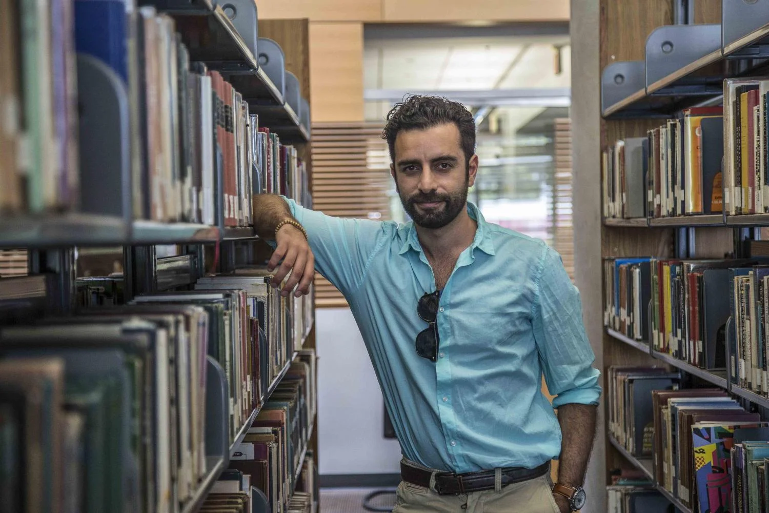 Arsi Nami, an award winning musician, an actor, music therapist and Santa Monica College alumni, walks the halls of the SMC library where he would spend a majority of his time as a SMC student. Nami was an international student at Santa Monica Community College, graduating from SMC with an Associates degree in music, where he would go on to California State University to receive his Bachelors degree in music therapy. At the Santa Monica College Library in Santa Monica California, on Thursday, April 27 2017. Matthew Martin.