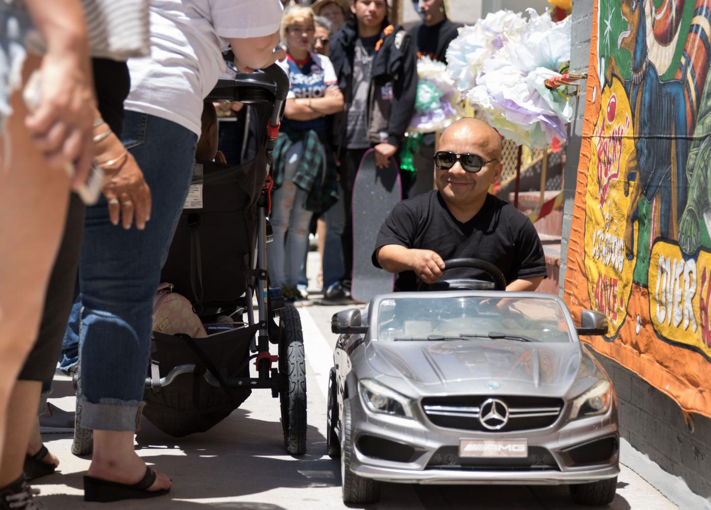  Venice Freakshow performer Gabriel, the smallest man in America takes his car for a ride around the boardwalk at the Venice Beach Freakshow Farewell Party and Protest in Venice California on April 30, 2017. Zane Meyer-Thornton. 