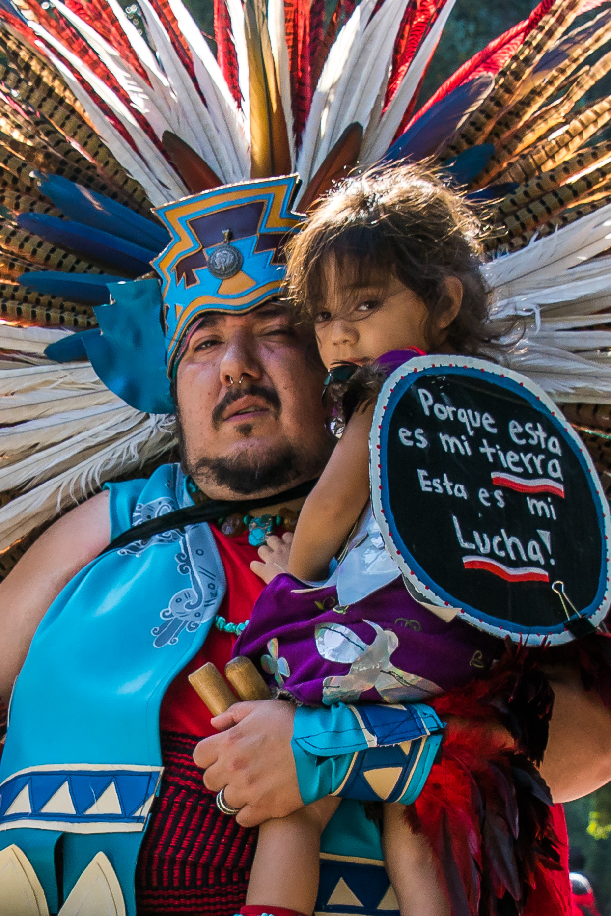  Raul Herrera (left) holds his daughter Xochipilli Herrera (right) after a long walk around Los Angeles City Hall at the replacement of Columbus Day with Indigenous Peoples Day which was successful on August 30, 2017 in Los Angeles, California (Photo