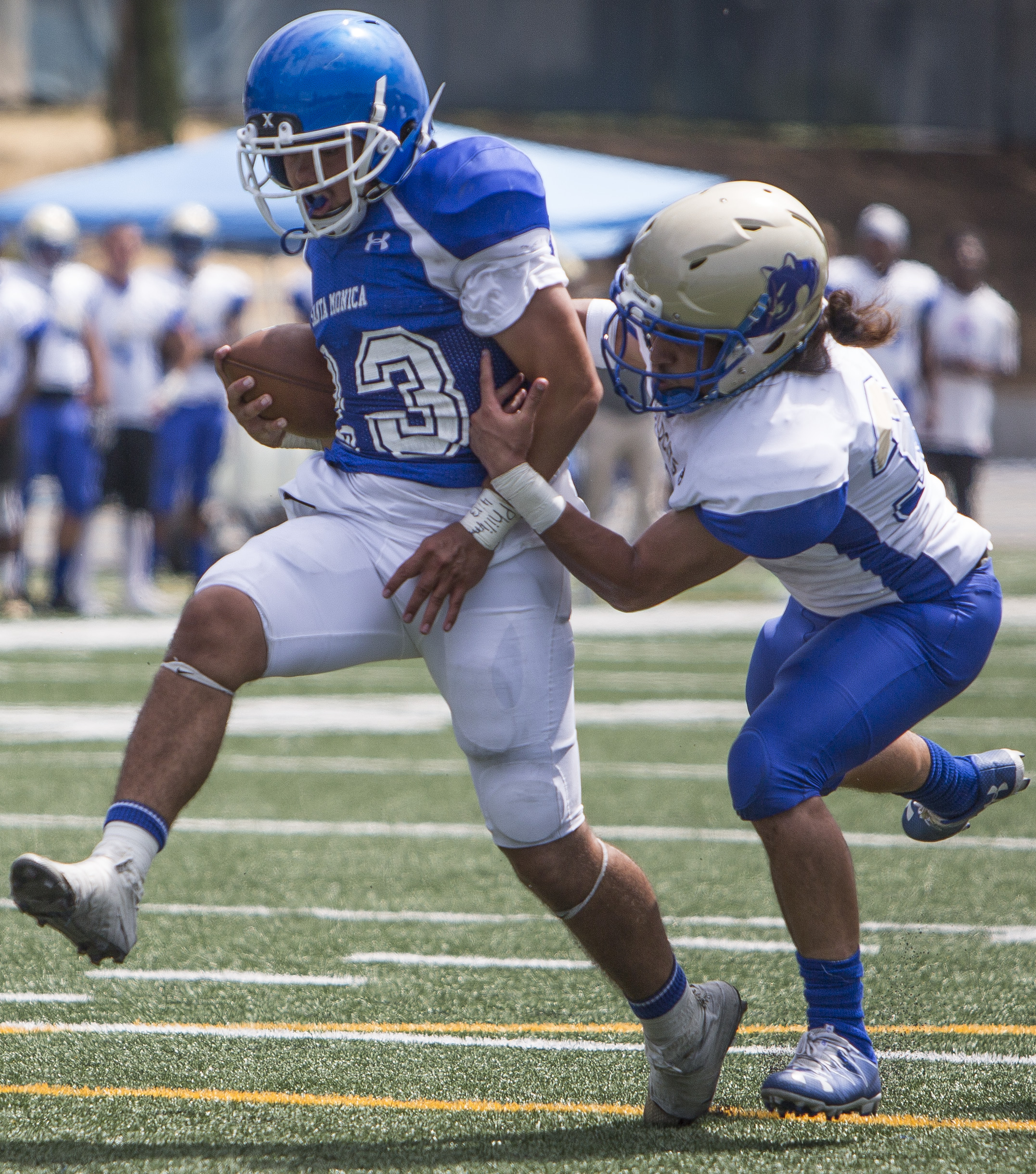  The Santa Monica College Corsairs Mens football Team player runningback Kahlil Miller (23) (blue,left) runs in for a touchdown passing The West La College Wildcats defensive back Alexander Leota (white,right) (37), Friday, September 2nd, 2017, at We